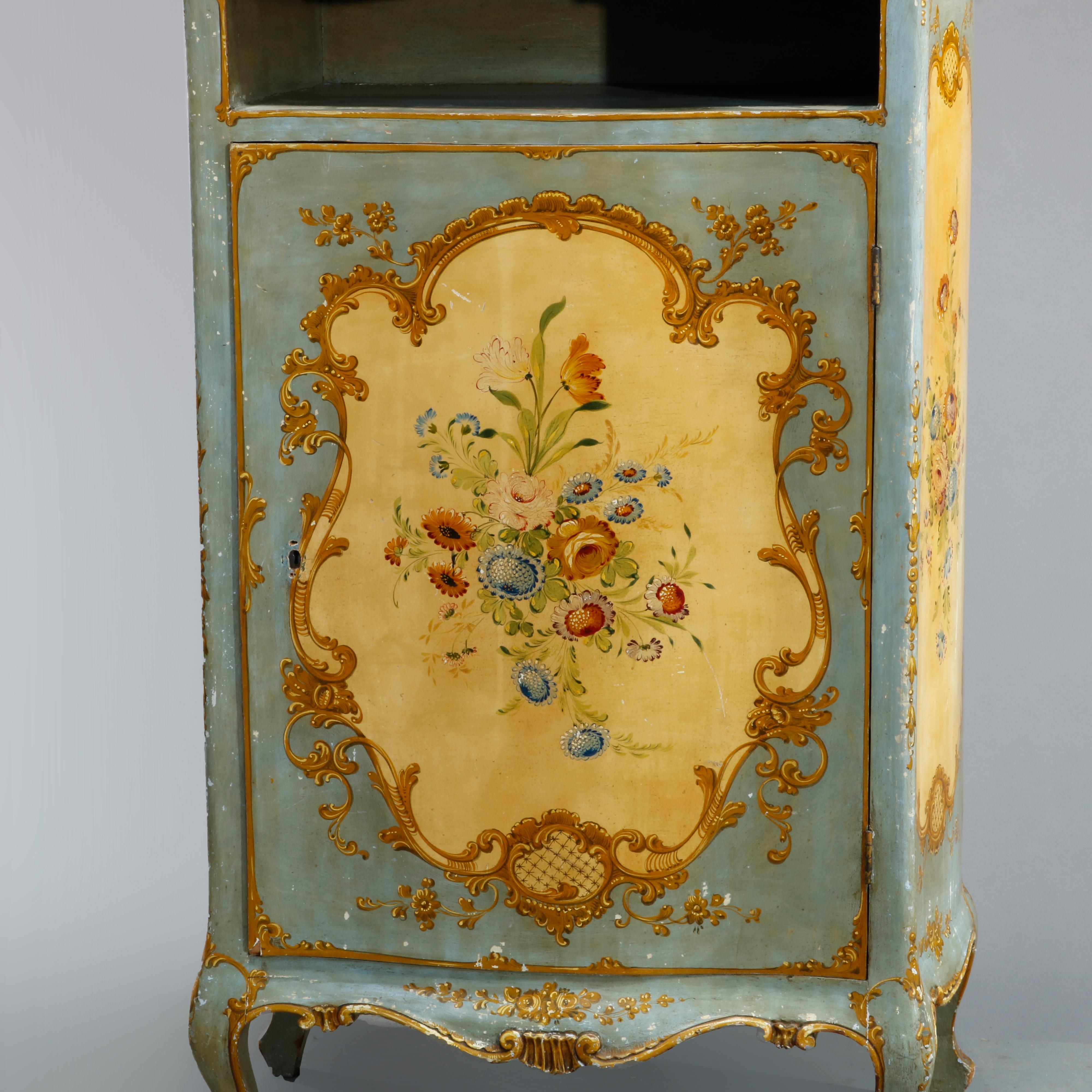 An antique French Bombe music cabinet offers wood construction with hand painted floral reserves, scroll, foliate and gadroon elements, shaped top over shelf and single door cabinet, raised on cabriole legs, c1890.

Measures: 40.25