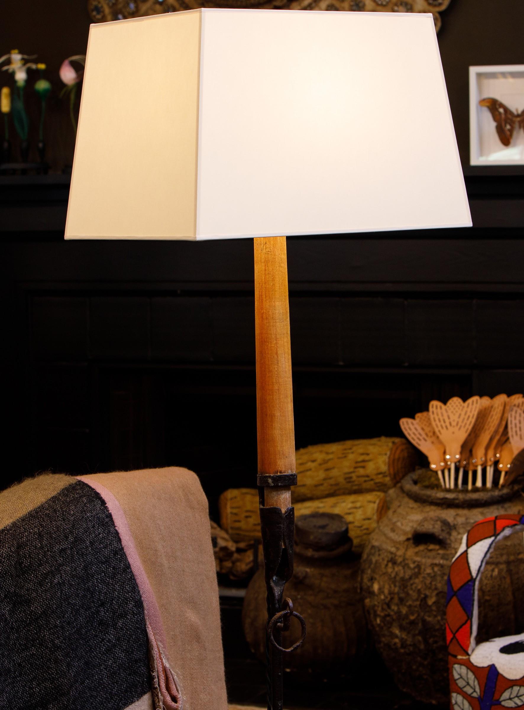 This hand-forged floor lamp has its original 
candle intact.  The candle is wood with some wax over the wood.  
The lamp has been wired for the US.  Its simple design is suitable for most homes and styles.
