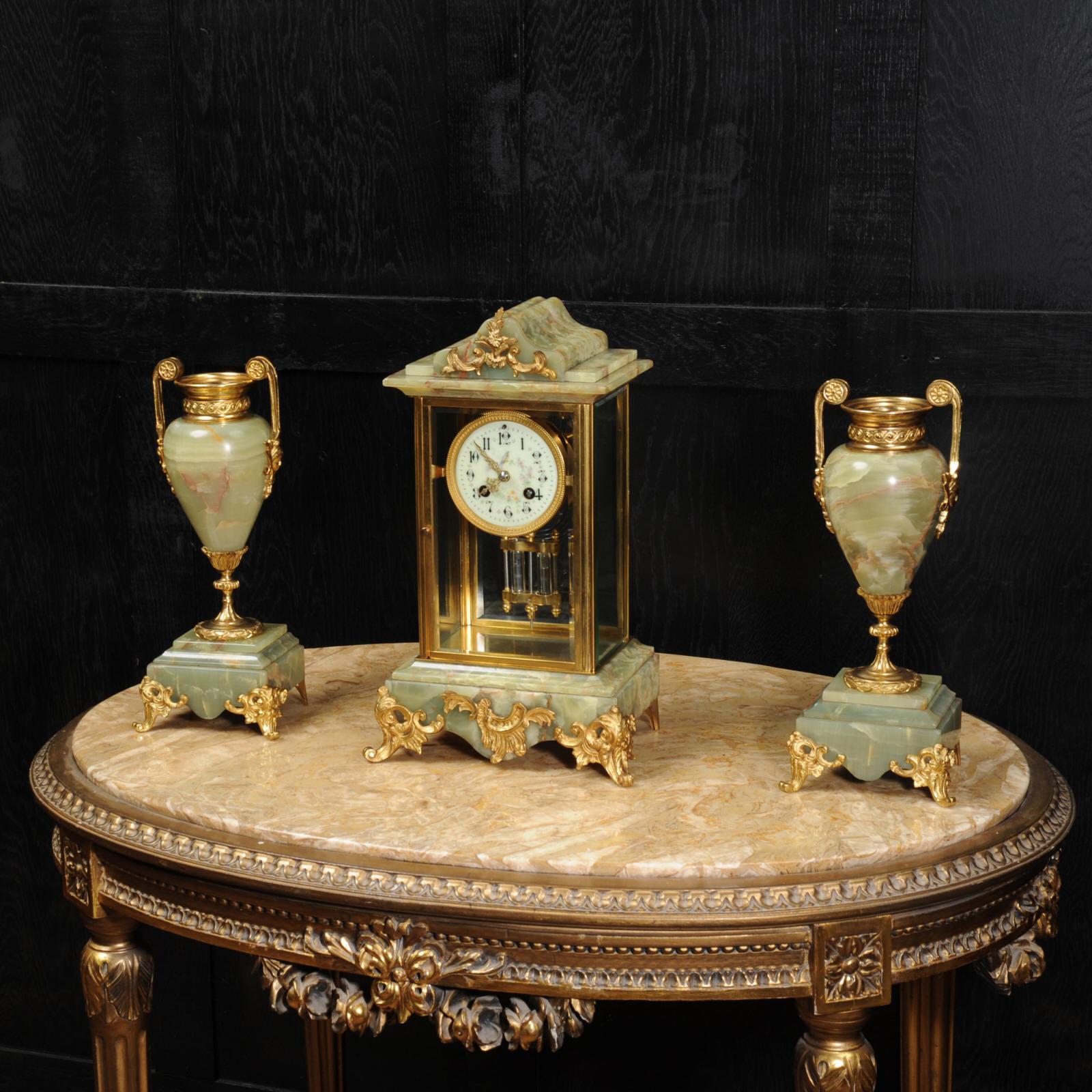A superb and chic antique French four glass regulator. It features a mercury compensated pendulum gently swinging behind the bevelled glass. The case is constructed of beautifully variegated onyx, mounted with ormolu and is classical in design. The