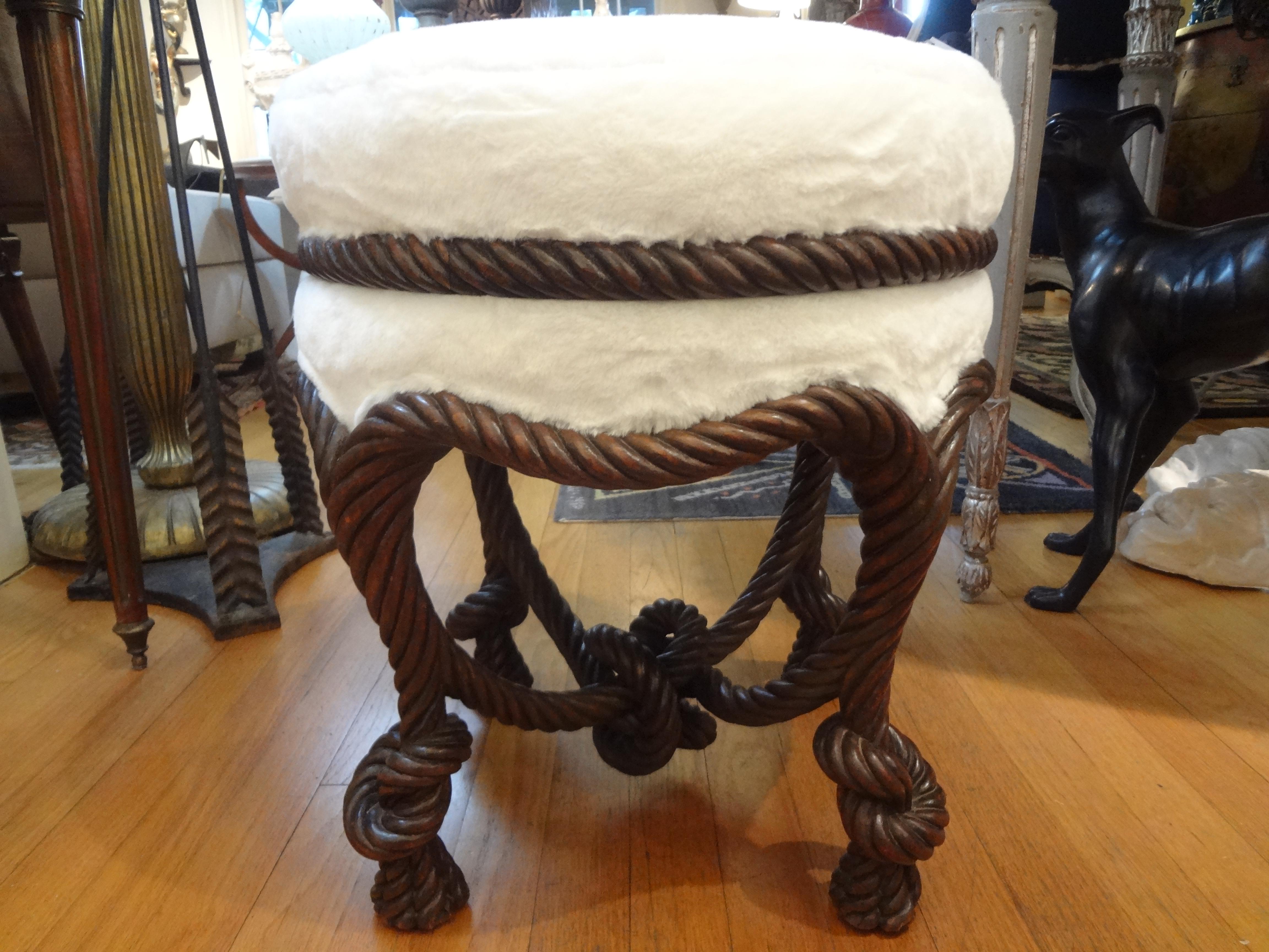 Stunning antique French A.M.E. Fournier style carved wood ottoman, bench, stool, tabouret or pouf with a knotted cross stretcher and knotted tassel legs. This beautiful French Louis XVI style-Napoleon III style pouf has been professionally