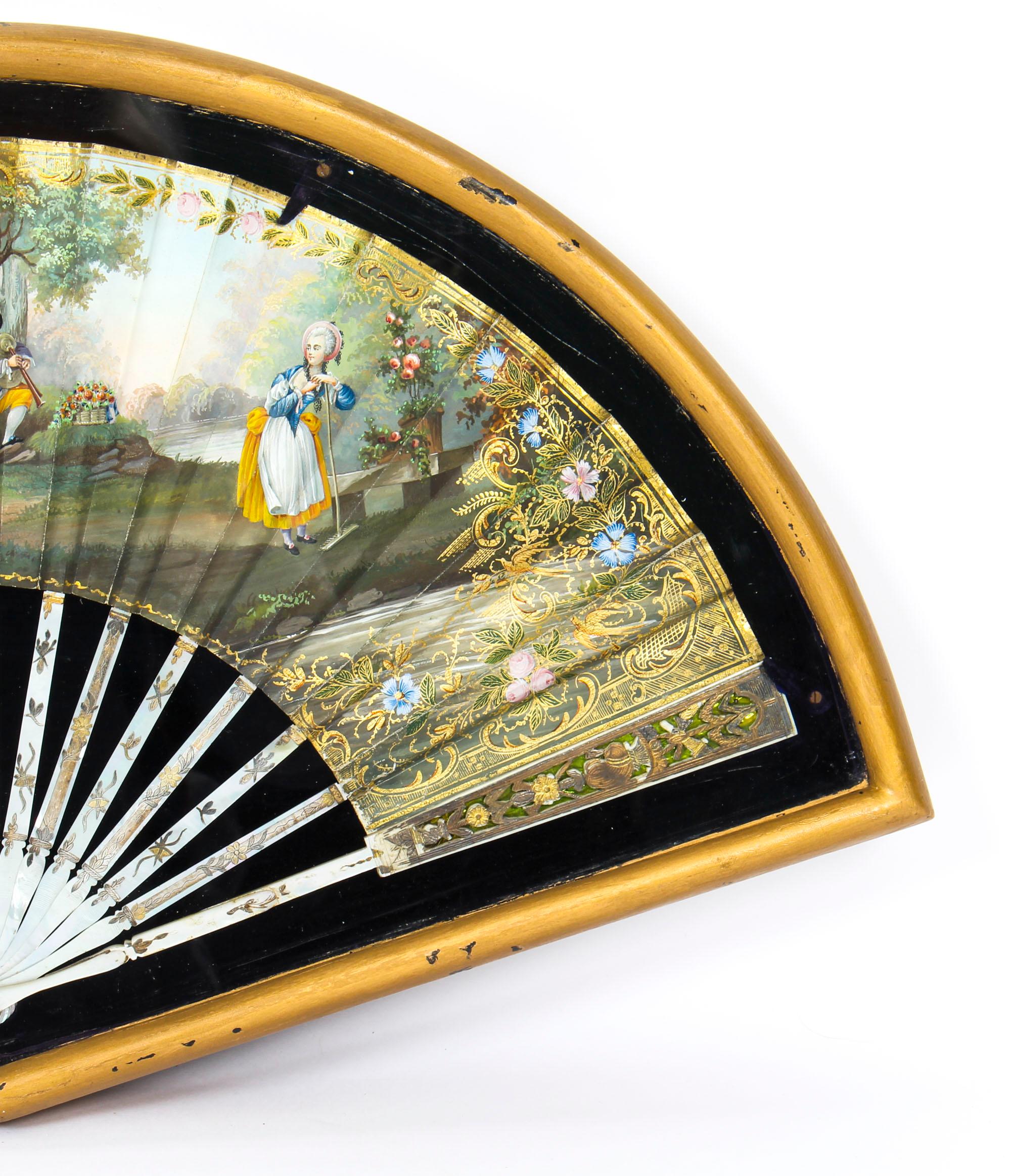 This is a truly splendid antique and highly decorative French painted mother of pearl fan set in a gilded and glazed box frame, dating from the late 18th century.

This wonderful fan is beautifully hand painted with stunning figures dressed in