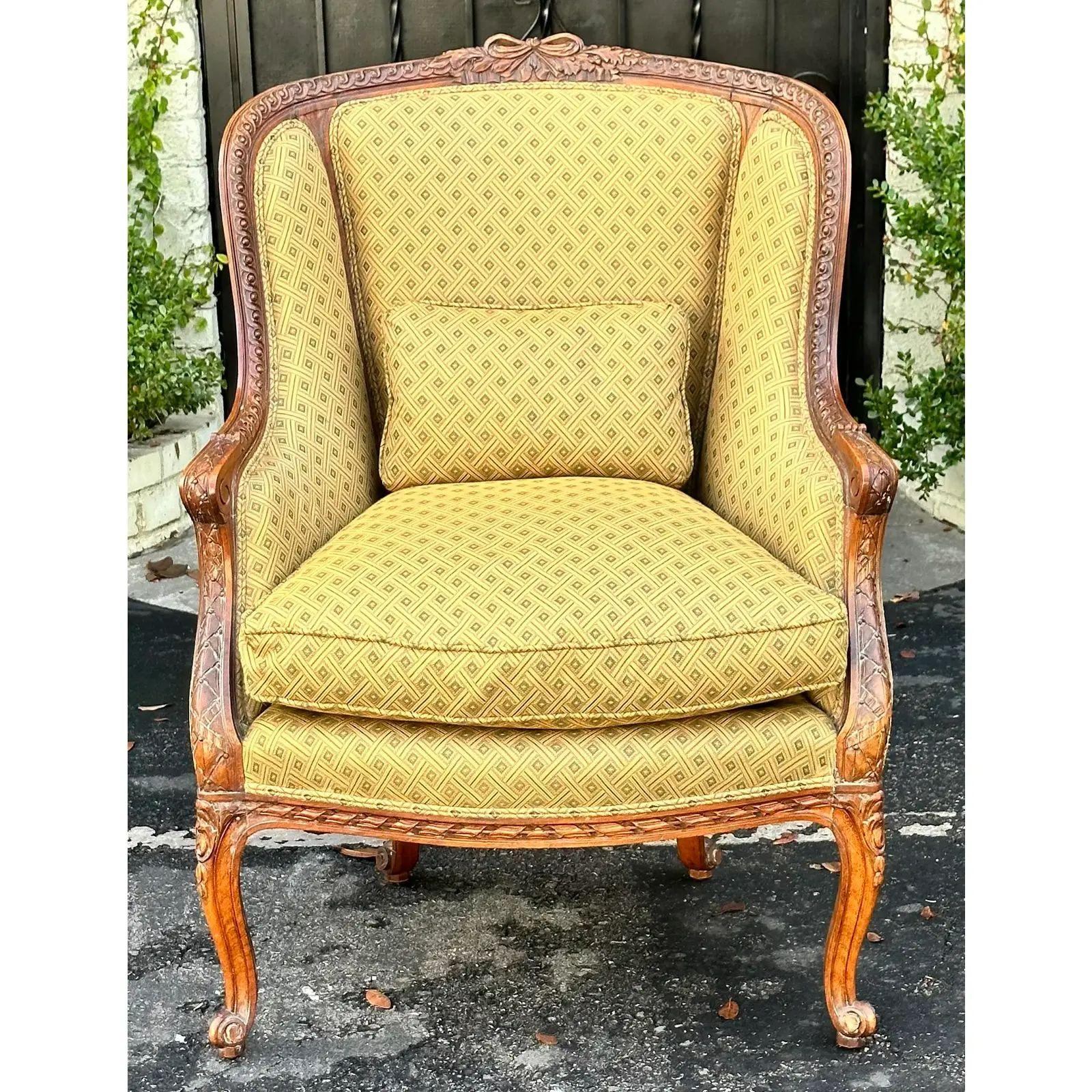 Antique 19th century French fruitwood bergere armchair. It is of superb quality and features down filled cushions and exquisitely carved details.

Additional information: 
Materials: Feather, fruitwood
Color: Olive
Period: 19th century
Number