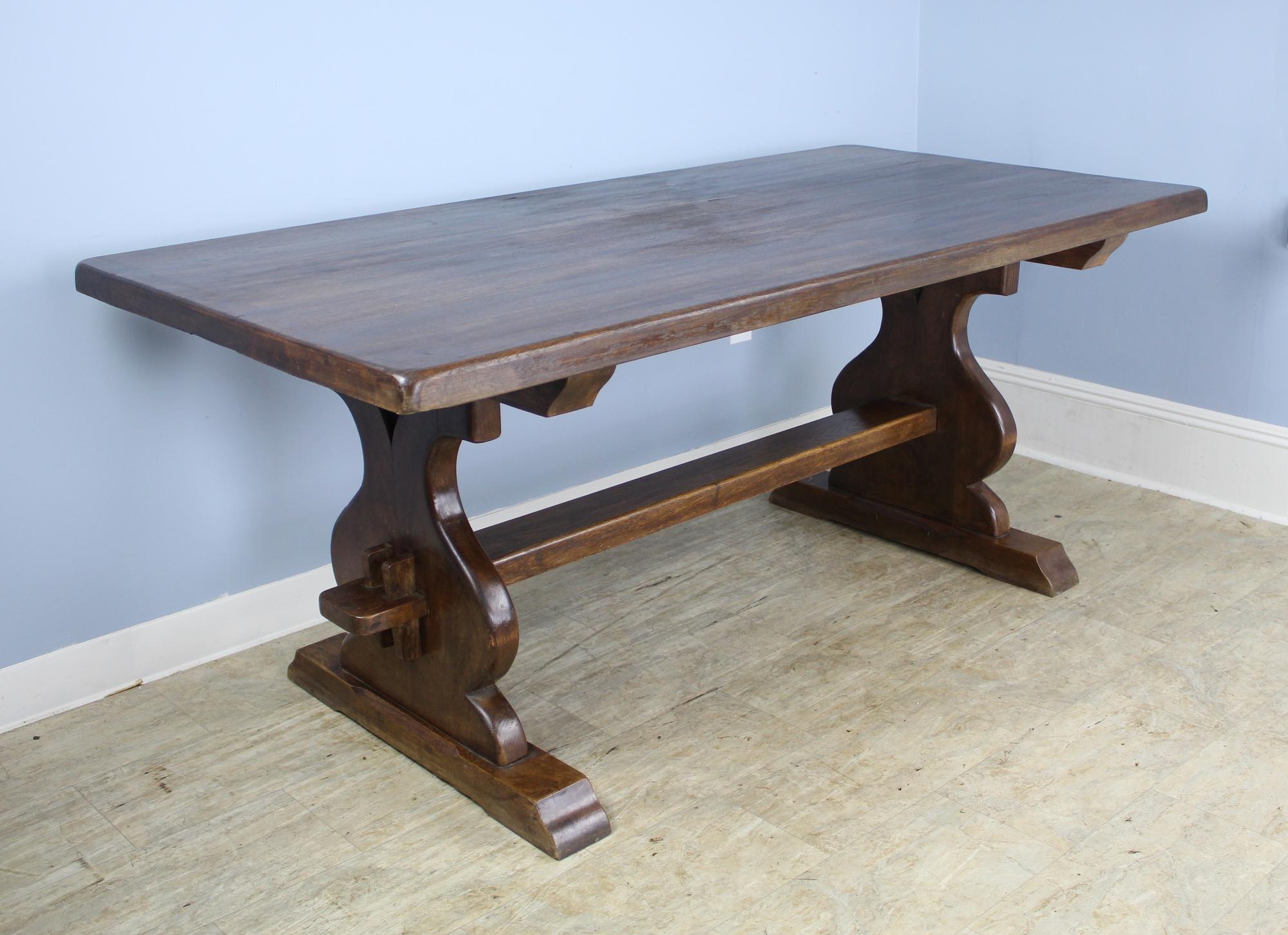 A handsome and beautifully crafted antique French fruitwood refectory table with a 2 inch thick top and marvellous construction and design on the trestle base. With no apron to get in the way, this table can comfortably accommodate eight. Great