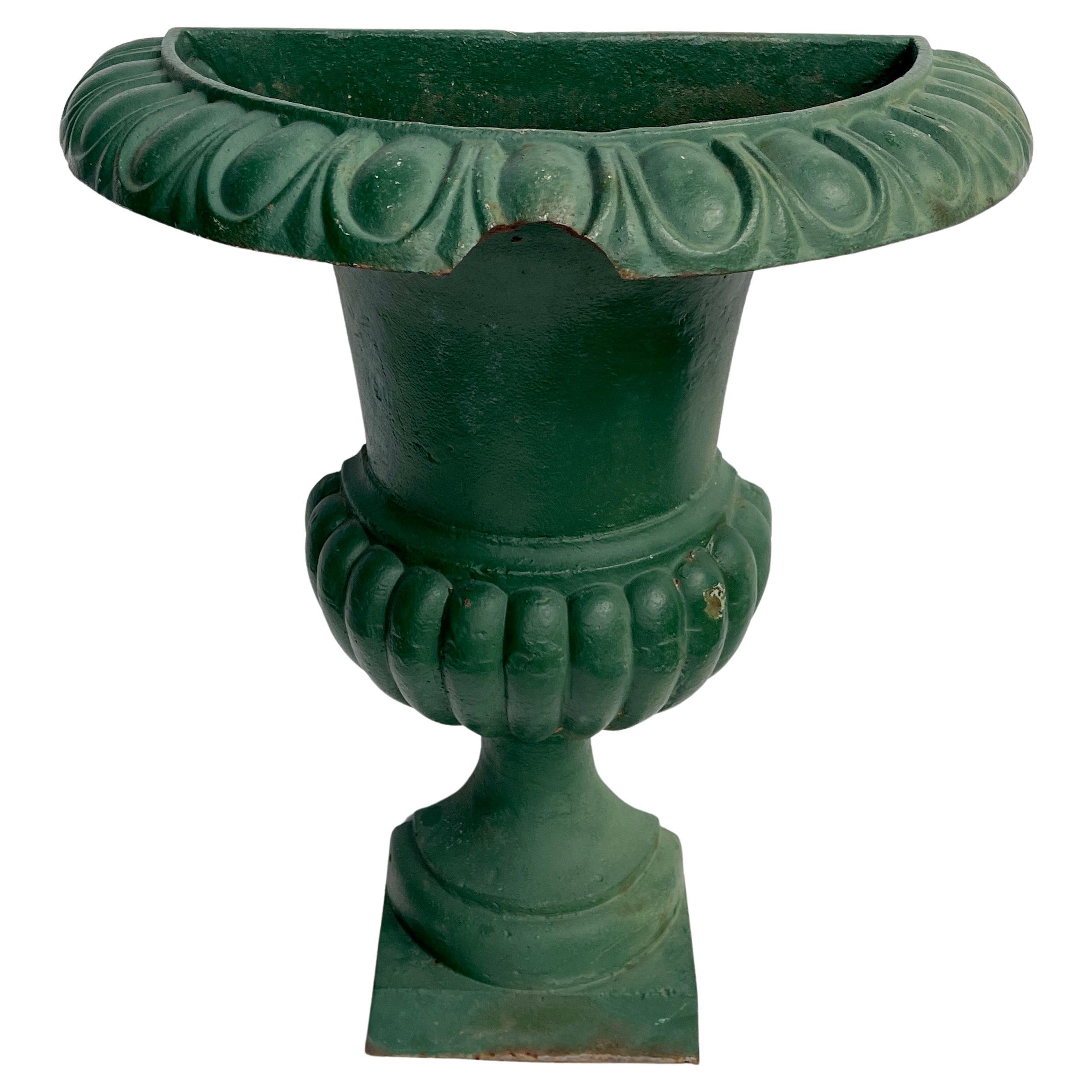 French Demi Lune Green Patina Fluted Planter Pedestal

Charming and substantial early 20th Century antique French cast iron half round wall planter. This rare piece appears to have been repainted many years ago in a wonderful shade of green. The