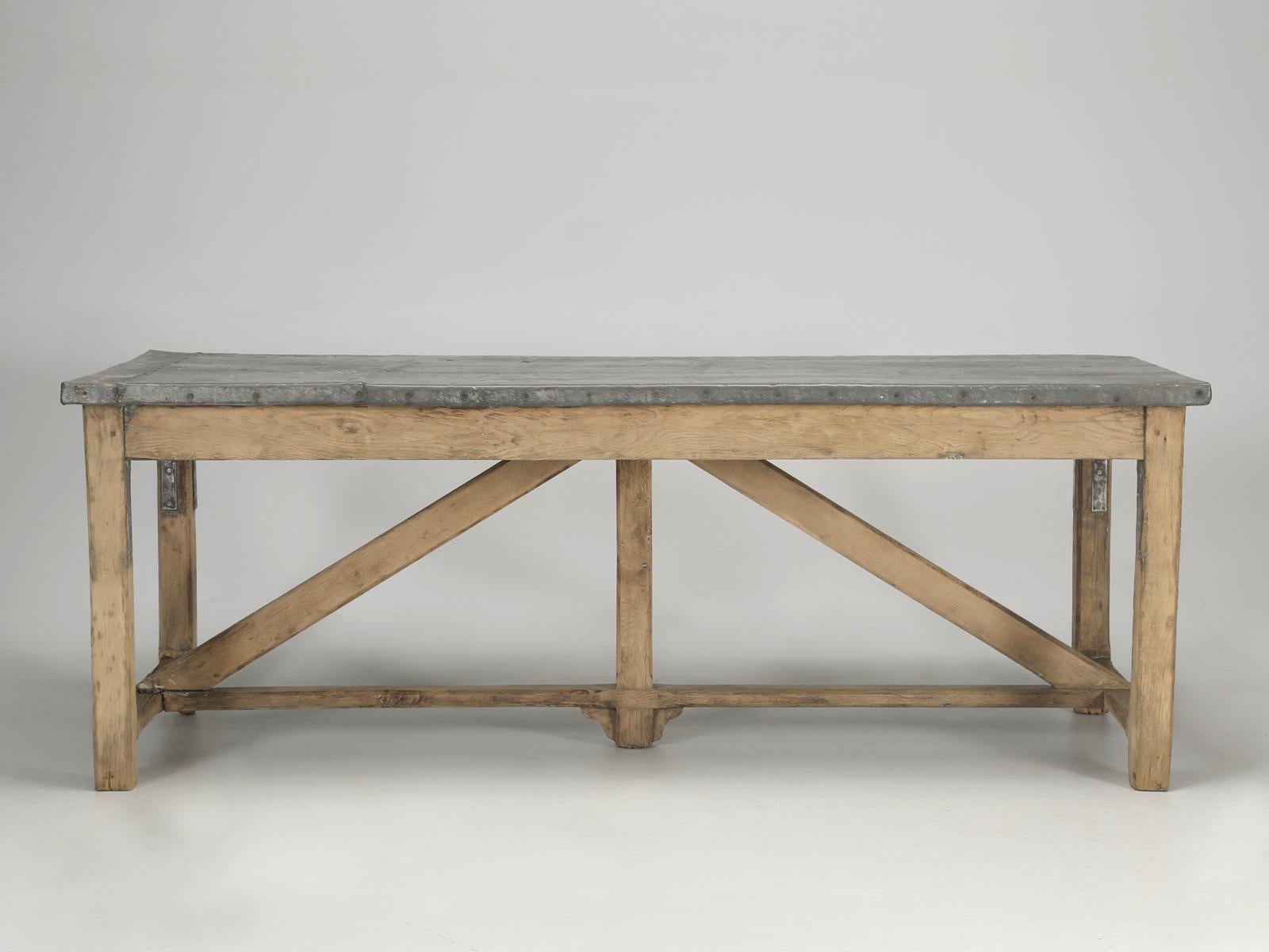 Antique Country French Industrial style table that probably was used outdoors for an extended period of its life. Our work table was discovered in the Toulouse area of France and was sitting in a barn. We chose to leave it exactly as found and if