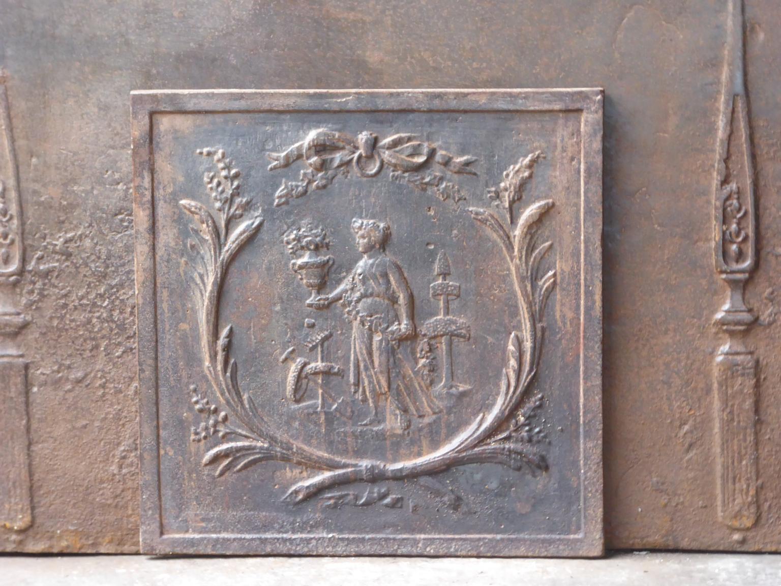 19th century French Napoleon III period fireback with a gardening scene.

The fireback is made of cast iron and has a natural brown patina. Upon request it can be made black / pewter at no extra cost. The fireback is in a good condition. It does not
