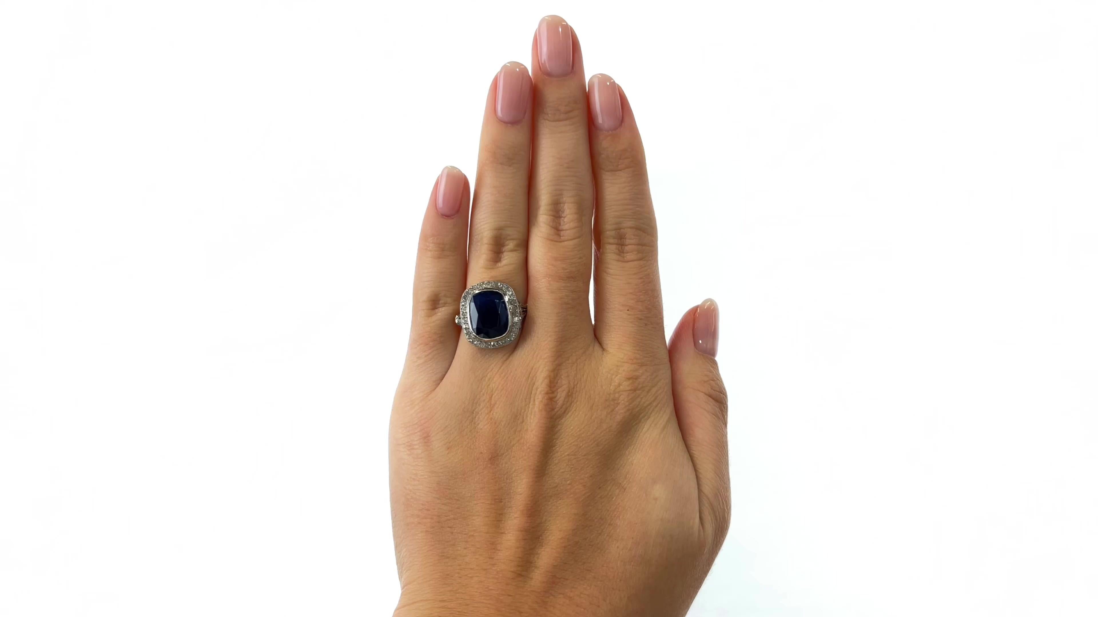 One Antique French GIA 6.97 Carat Sapphire Diamond Platinum Cocktail Ring. Featuring a 6.97 carat cushion cut sapphire accompanied with GIA certificate #5222130554 stating the sapphire is of Cambodian origin and has not been heat treated. Accented