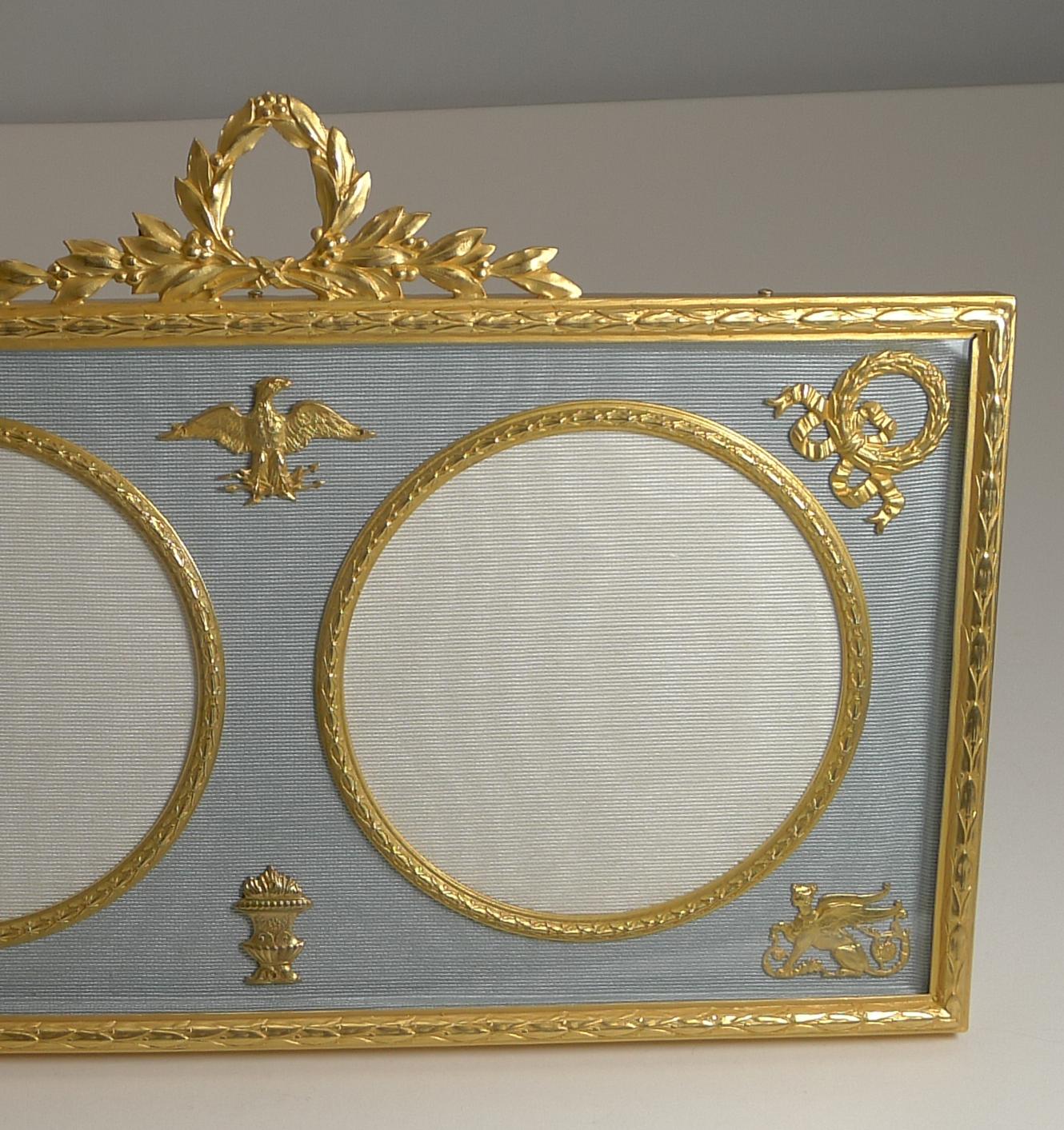 A very fine late Victorian Ormolu photograph / picture frame, French in origin and beautifully restored to it's former glory.

Behind the glass the frame is decorated with a grey / blue silk taffeta with two circular picture apertures measuring 3