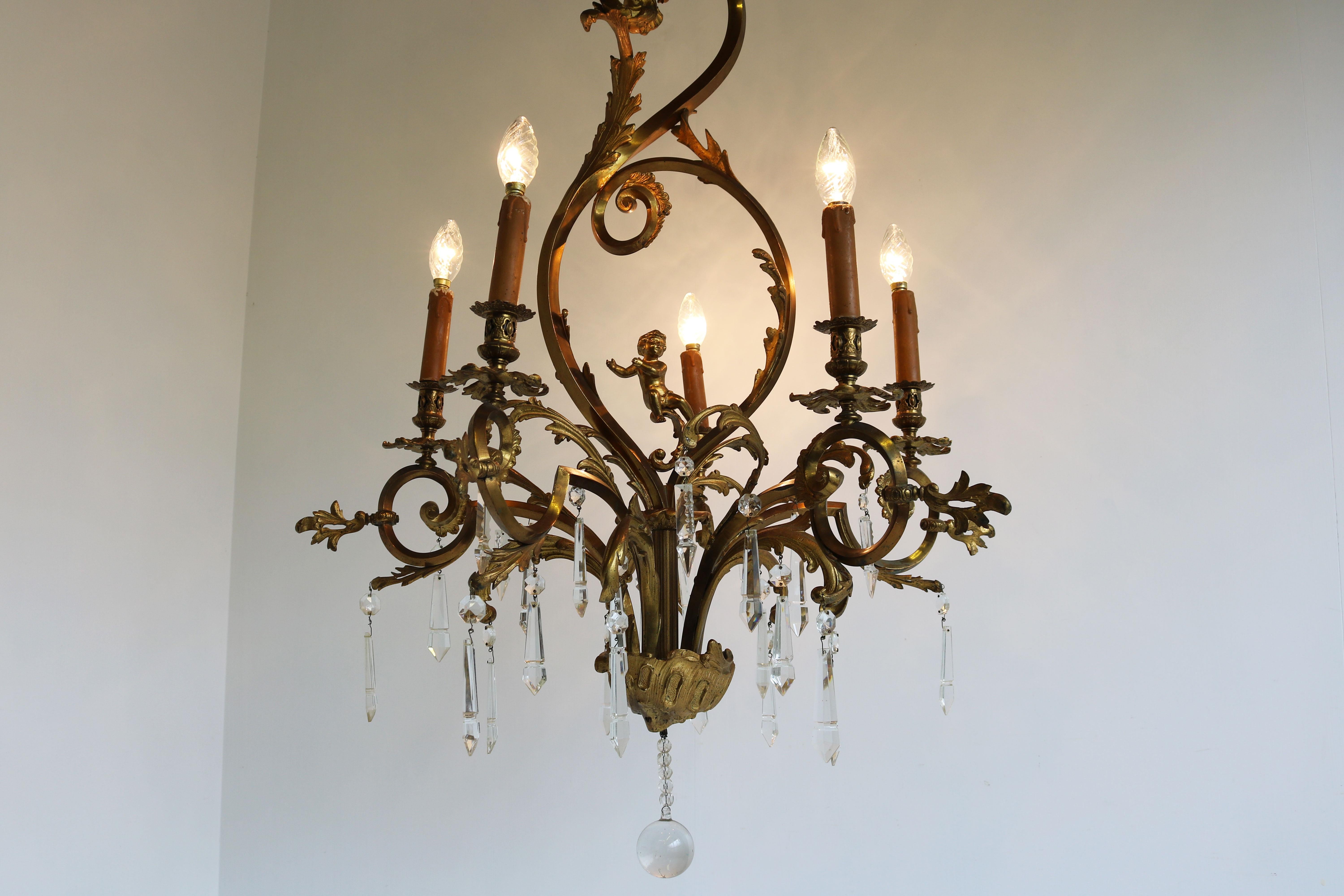 Exquisite gilded bronze chandelier from France Louis XV style / Rococo Revival 1880.
Crystal glass drops combined with the gilded bronze rococo curves makes it feel & look very luxurious. 
The chandelier has an impressive size and is a true
