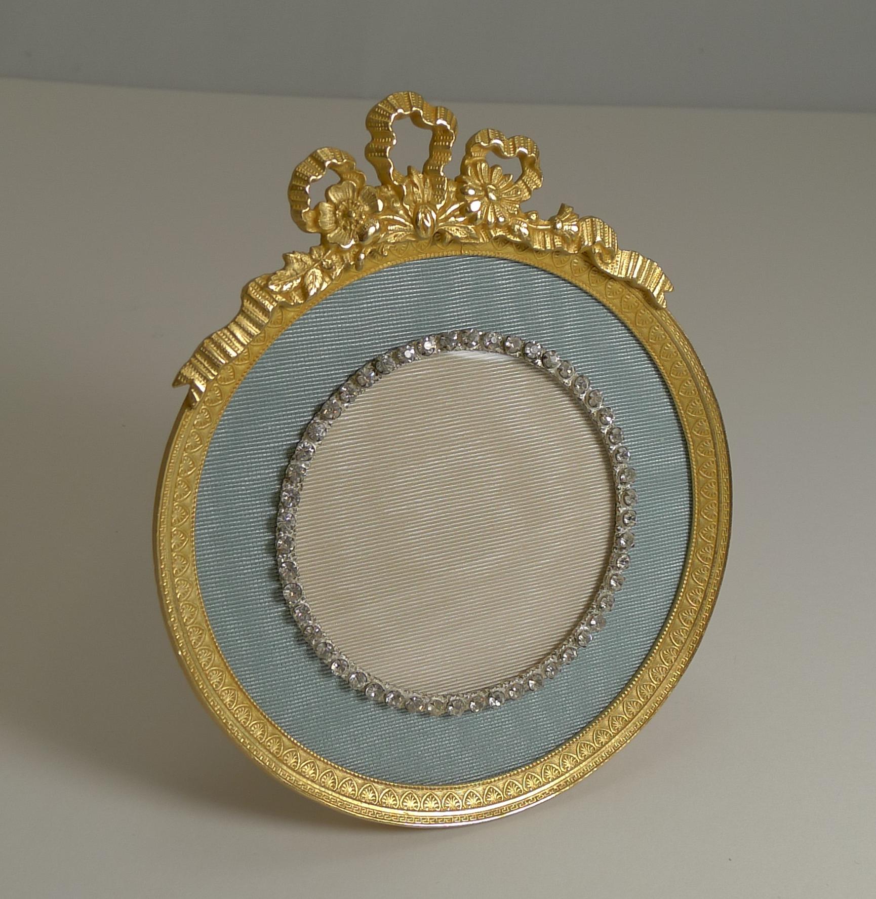 A stunning Ormolu photograph frame restored to it's former glory, dating from circa 1900.

The central circular aperture (measuring 2 3/4