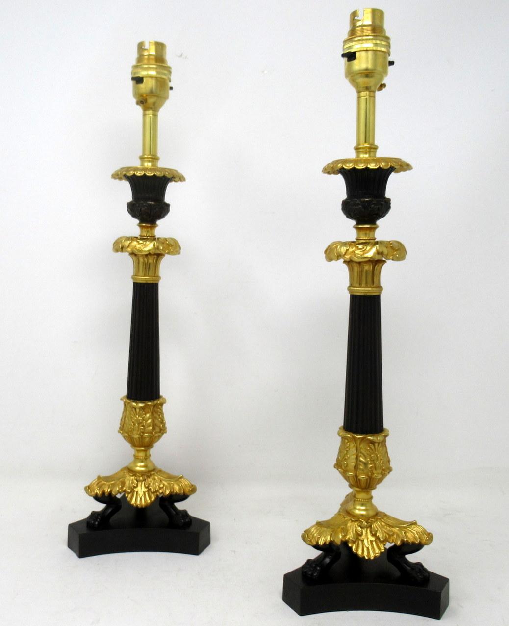 Stunning identical pair French heavy gauge ormolu and bronzed single light candlesticks of average size proportions, now converted to a pair of electric table lamps, with tapering reeded central bronzed column, each ending with three very ornate