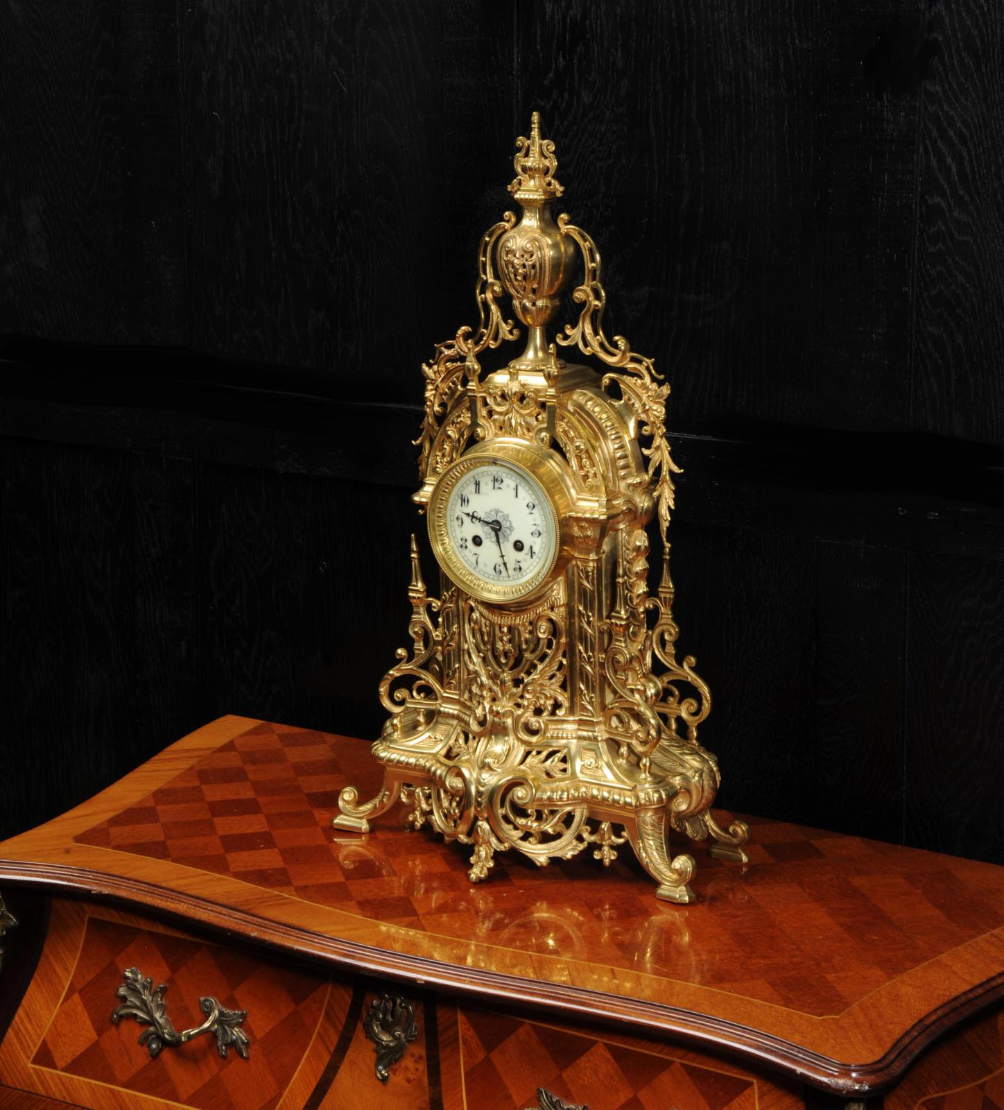 A large and stunning original antique French clock by A.D. Mougin, circa 1900. It is beautifully made from gilded bronze in the Baroque style. It is modeled with profuse, stylized acanthus with the front delicately fretted to allow a glimpse of the