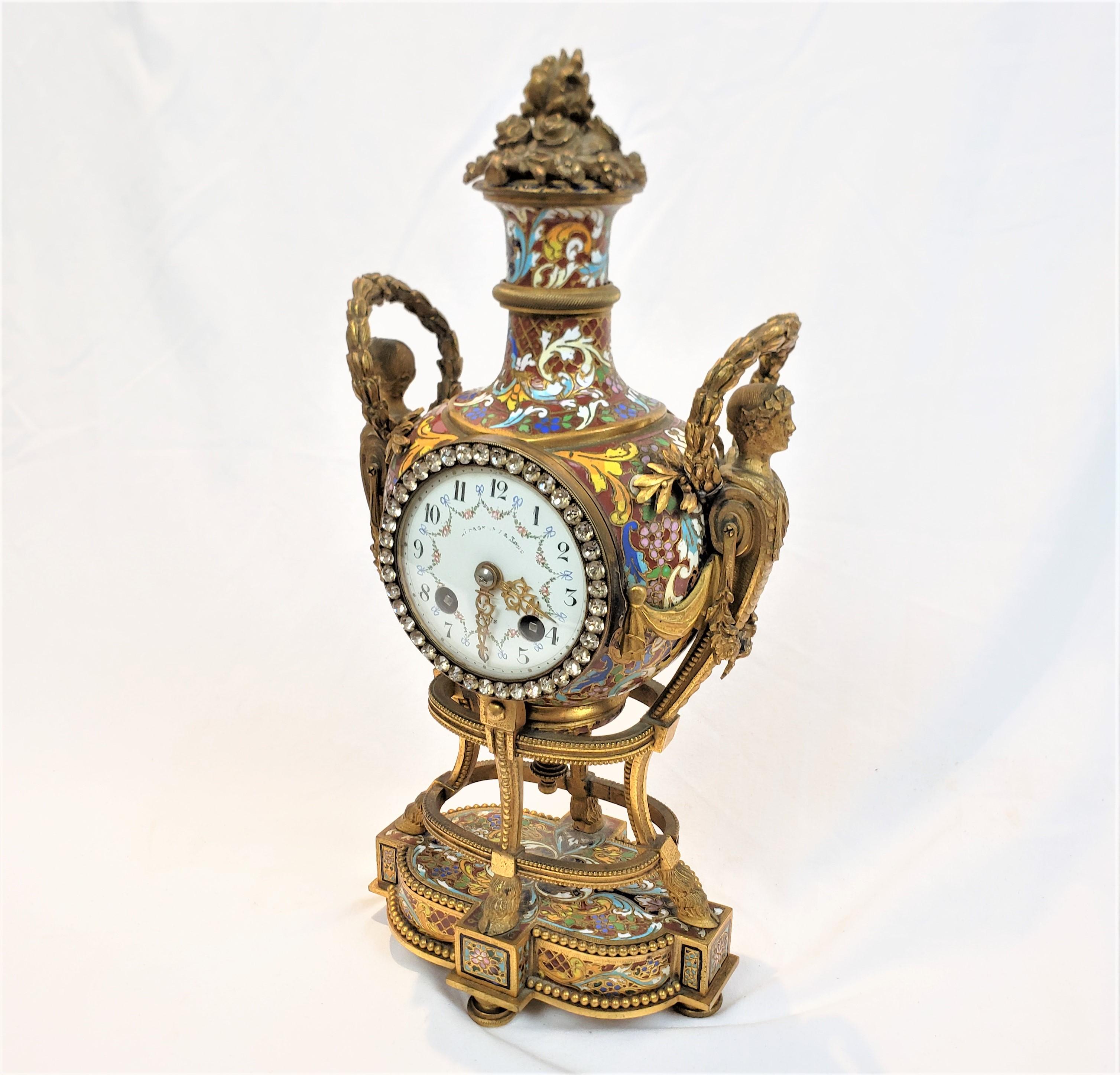 This 'Marie Anoinette' antique clock is signed on the face by an unknown maker, and originated from France and dating to approximately 1880 and done in the period Louis XVI style. The clock case is comosed of cast bronze with a gilt or ormolu