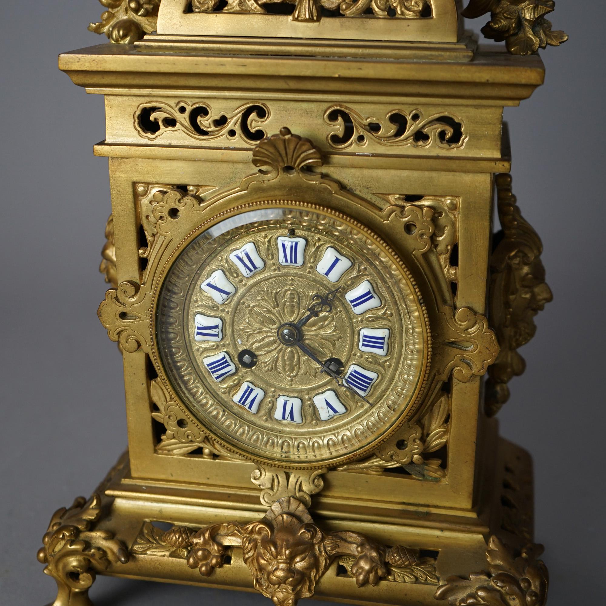 An antique French mantel clock offers gilt cast bonze footed case having battle armor form finial and scroll and foliate elements throughout, 19th century

Measures - 16.5
