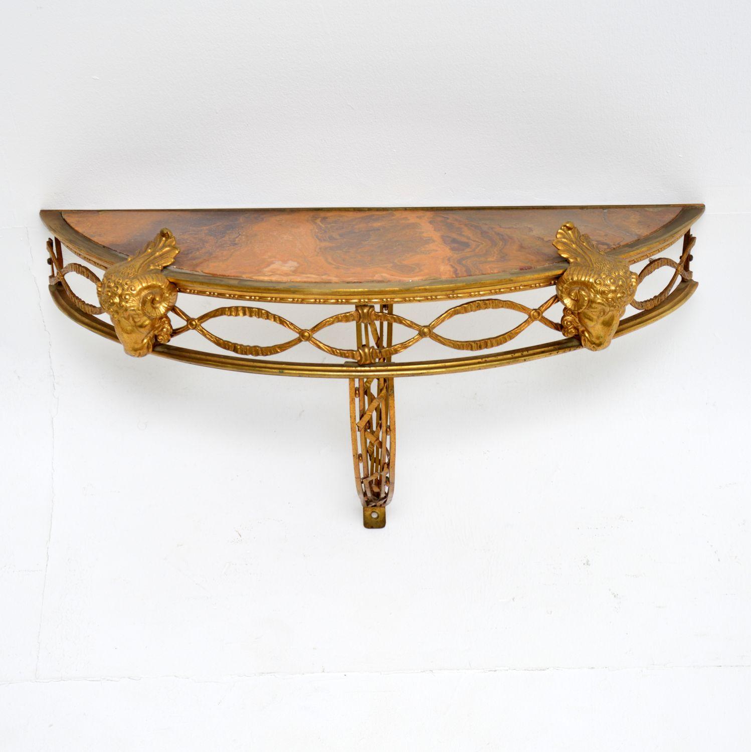 A stunning antique French wall mounting side table in gilt bronze with a marble top, dating from around the 1890-1900 period.

The quality is absolutely superb, the metal work is finely crafted and beautifully designed, with intricate details,