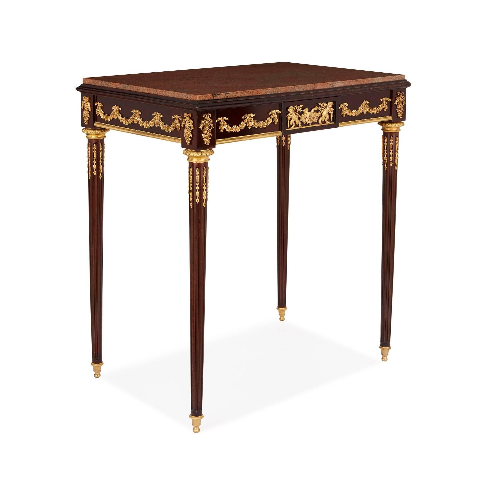 The beautiful neoclassical style designs of Jean-Henri Riesener (1735-1806), perhaps the most celebrated cabinetmaker of all time, are the inspiration for this wonderful antique side table. In particular, the ormolu mounts which adorn the piece -