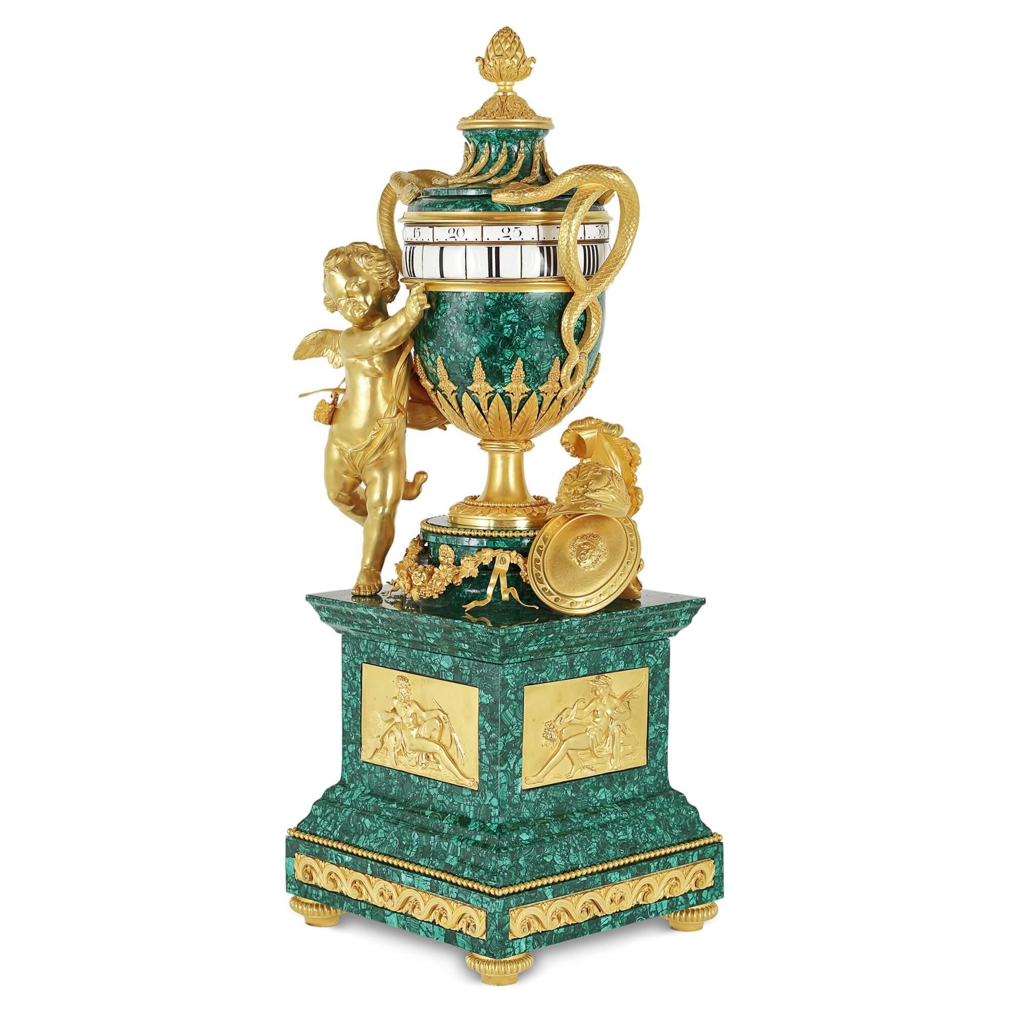 Antique French gilt bronze mounted malachite turning mantel clock
French, late 19th century
Measures: Height 75cm, width 28cm, depth 25.5cm

The malachite mantel clock case is styled like a classical amphora vase, which stands on a gilt bronze