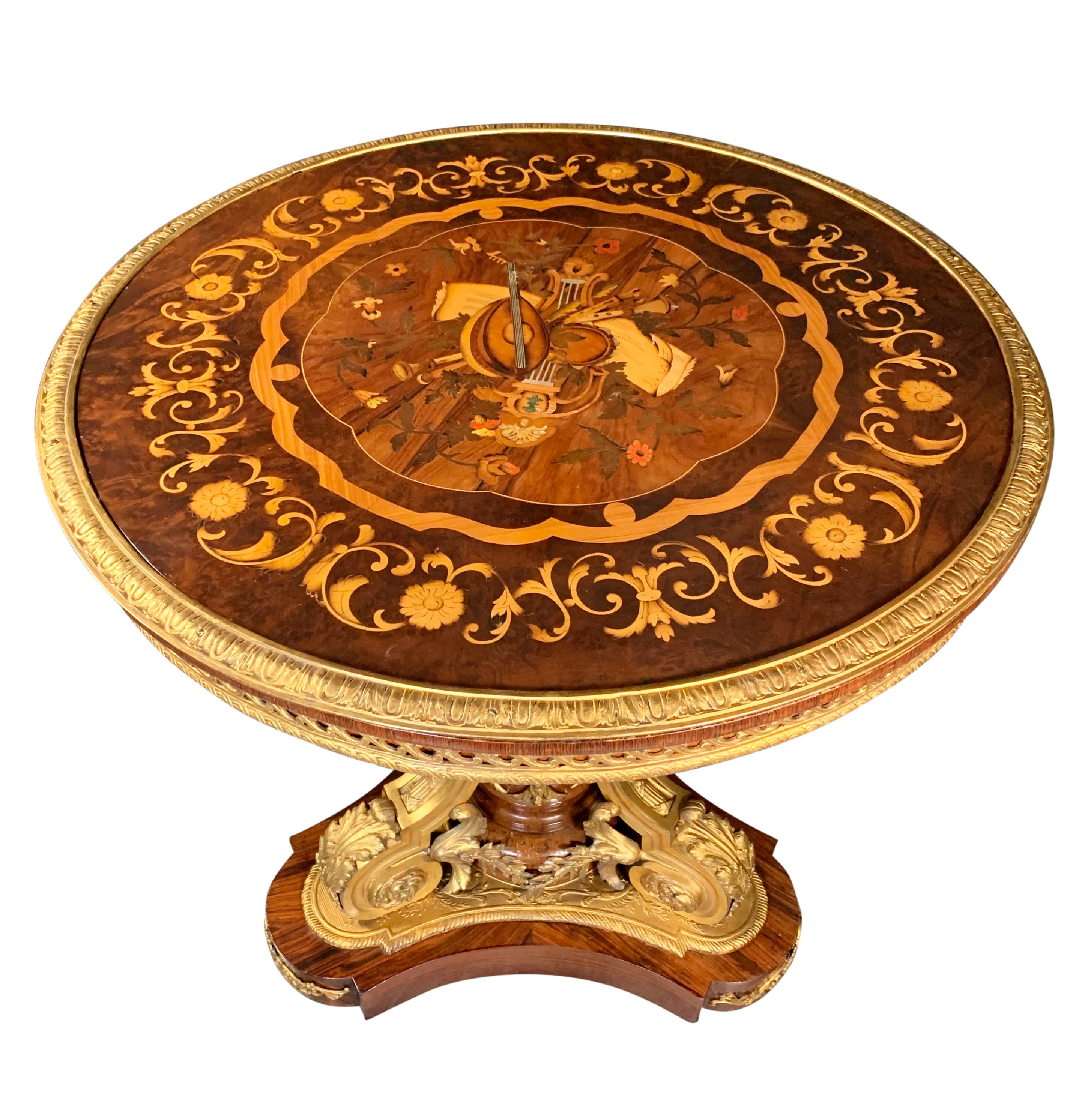 A FRENCH LOUIS XV STYLE ORMOLU MOUNTED & MARQUETRY CIRCULAR CENTER TABLE

France, Circa 1900

In the Louis XVI style the marquetry inlaid circular top decorated with exotic woods depicting musical instruments and foliage and bordered with a garland