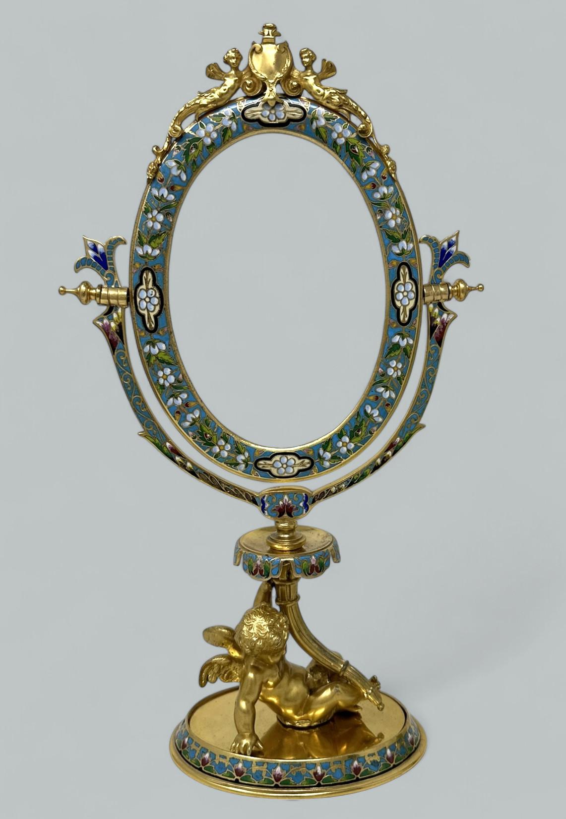 Absolutely Stunning French Floral Champleve Enamel pattern Hand Mirror of museum quality, third quarter of the Nineteenth Century. 

With a hinged oval shaped beveled looking glass within a colourful champleve enamel floral pattern frame, the top