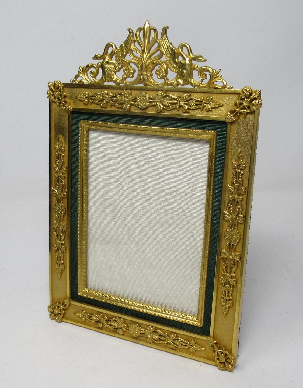 A stunning French Ormolu standing photo frame of medium proportions, mid-late 19th century. 

The rectangular shaped highly decorative ormolu cushioned style frame enclosing a single portrait shape photo inset surmounted with a very ornate applied