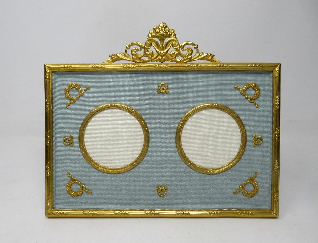 A stunning French Ormolu standing photo frame of medium proportions, mid-late 19th century.

The rectangular shaped ormolu reeded frame enclosing a pair of circular shape photo insets surrounded with finely cast applied decorations and a stunning