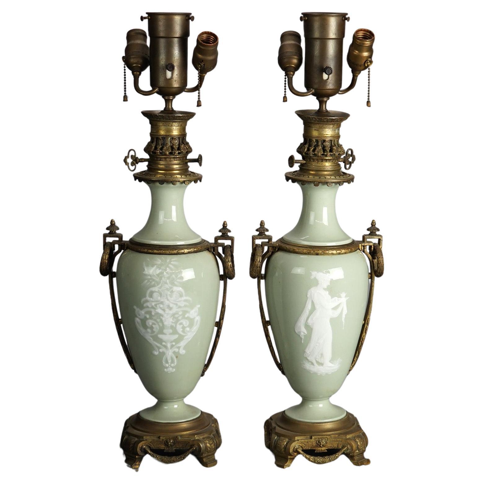 Antique Pair of French Cameo Triple Socket Table Lamps with Gilt Foliate Cast Bronze Bases & Mounts with Celadon Porcelain Urn Form Fonts with Figures, Circa 1920

Measures- 31.5''H x 9.5''W x 6''D