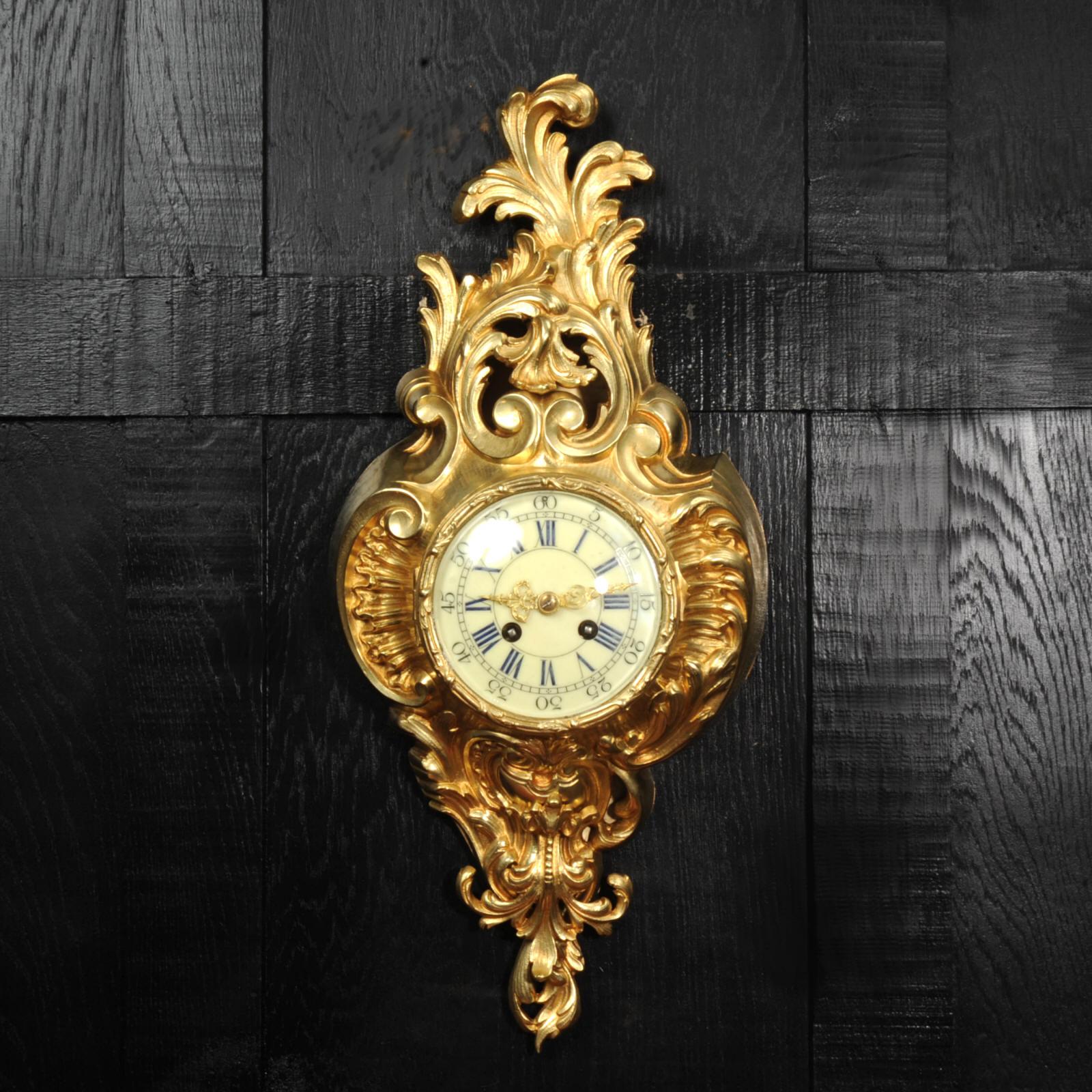 A very decorative antique French gilt bronze cartel wall clock by Vincenti, circa 1870. It is Rococo in style, asymmetric with acanthus shoulders and a large acanthus leaf top. Acanthus flowers hang below the dial. It is in stunning condition,