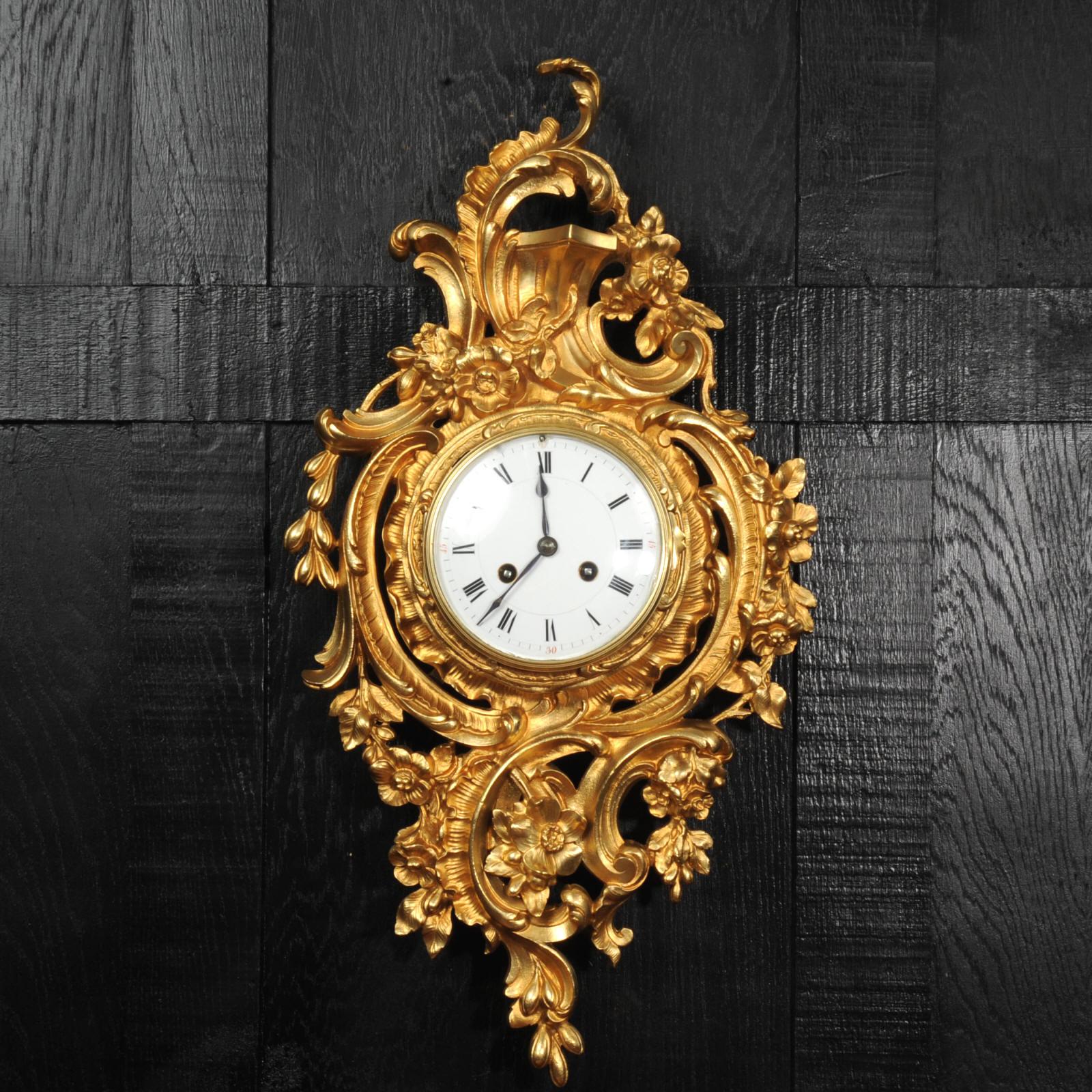 A beautiful antique French Rococo cartel wall clock, the movement by Vincenti et Cie and retailed in Paris, circa 1870. Beautifully modelled asymmetric case of 'C' scrolls, profusely decorated with garlands of flowers. A glimpse of the pendulum can