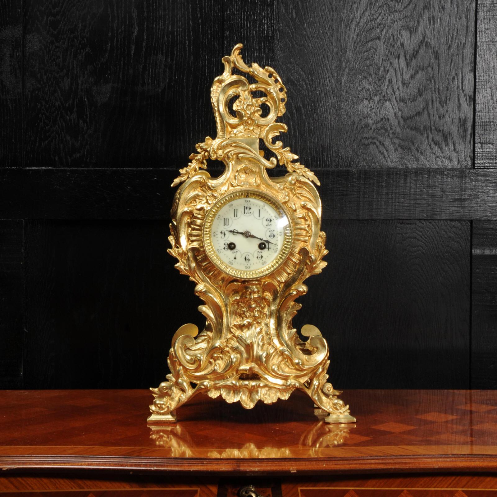 A lovely antique French clock, circa 1890, boldly modelled in the Rococo style in gilded bronze. A mask of Neptune just below the dial sits in the midst of a spectacular boiling sea that forms the lower part of the case. Dolphins riding the surf