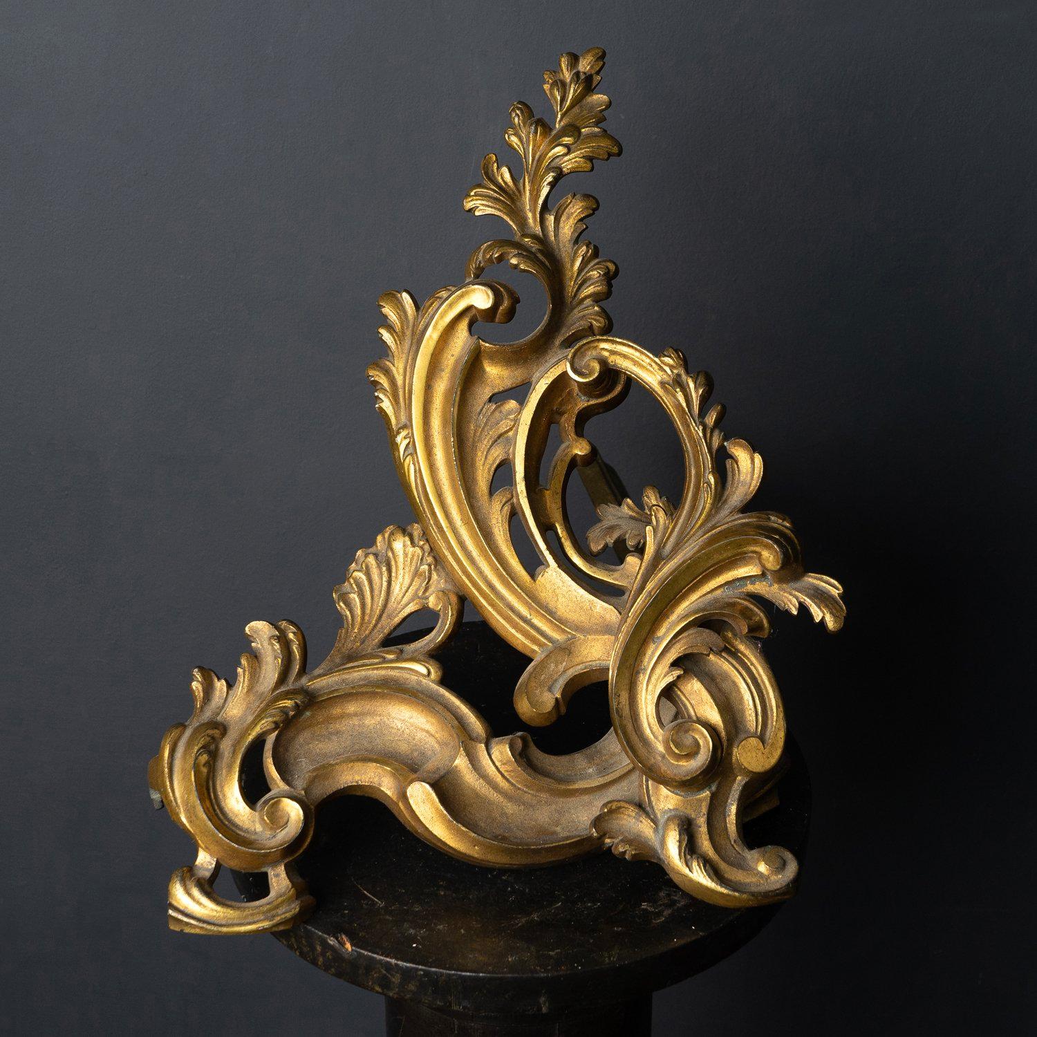 Single Louis XV Style Fireplace Andiron

Single chenet seeks an equally glamorous partner in crime to sit by the fire with. Or failing that, to find someone who only needs one.
Flowing rococo style andiron modelled in a naturalistic form gilt