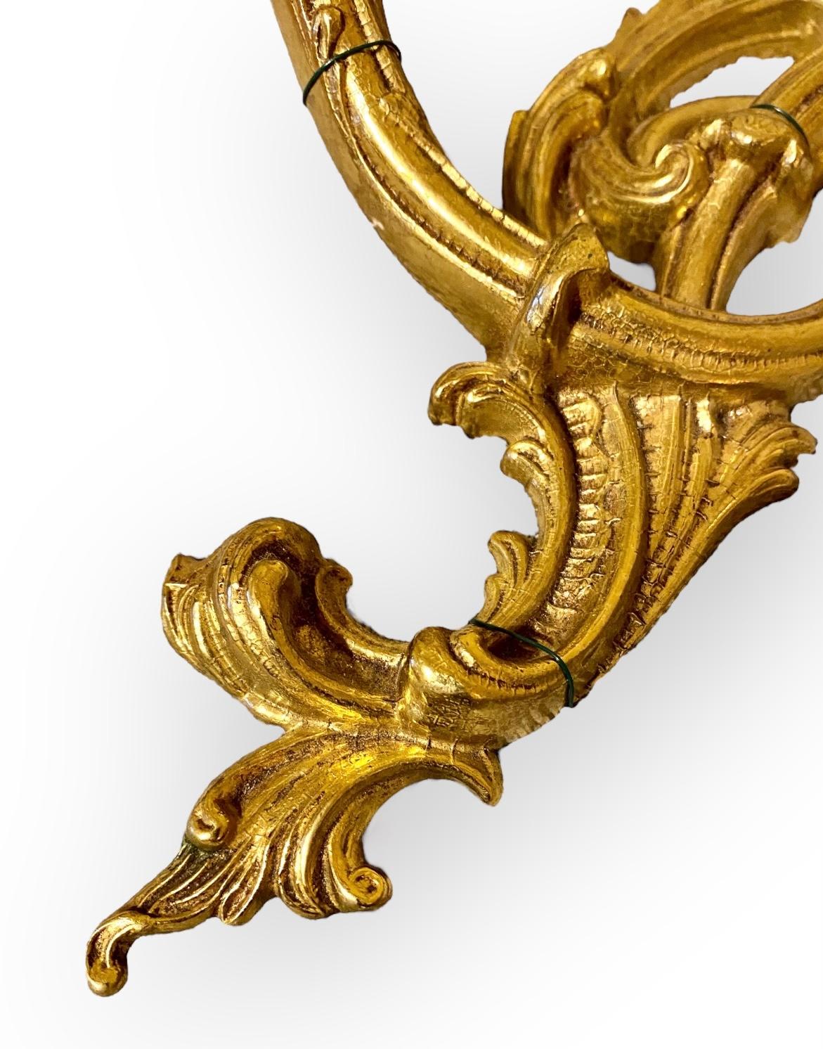 An antique French Louie XV style gilt bronze two light wall sconce with lovely Ivory silk clip on shades. 
Add a chic French atmosphere to one of your favorite spaces with this unique wall sconce.. lighted in the evening it offers a warm welcoming