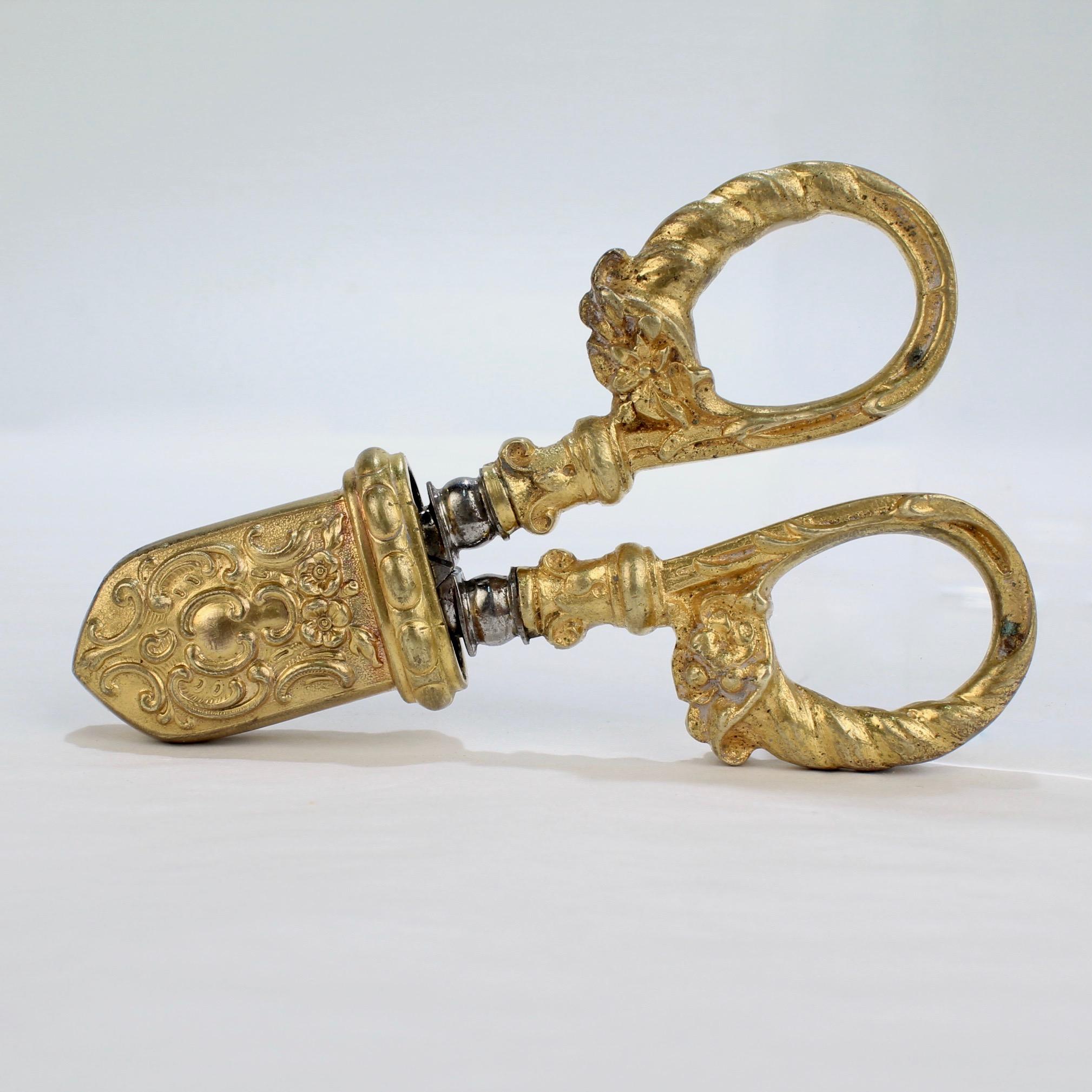 A wonderful pair of antique Champagne nippers or wire cutters.

Likely French with an ornate gilt bronze sheath, cornucopia handles, and steel blades.

A real rarity and a must-have for any wine collector!

Length: ca. 3 3/4 in.

Items purchased