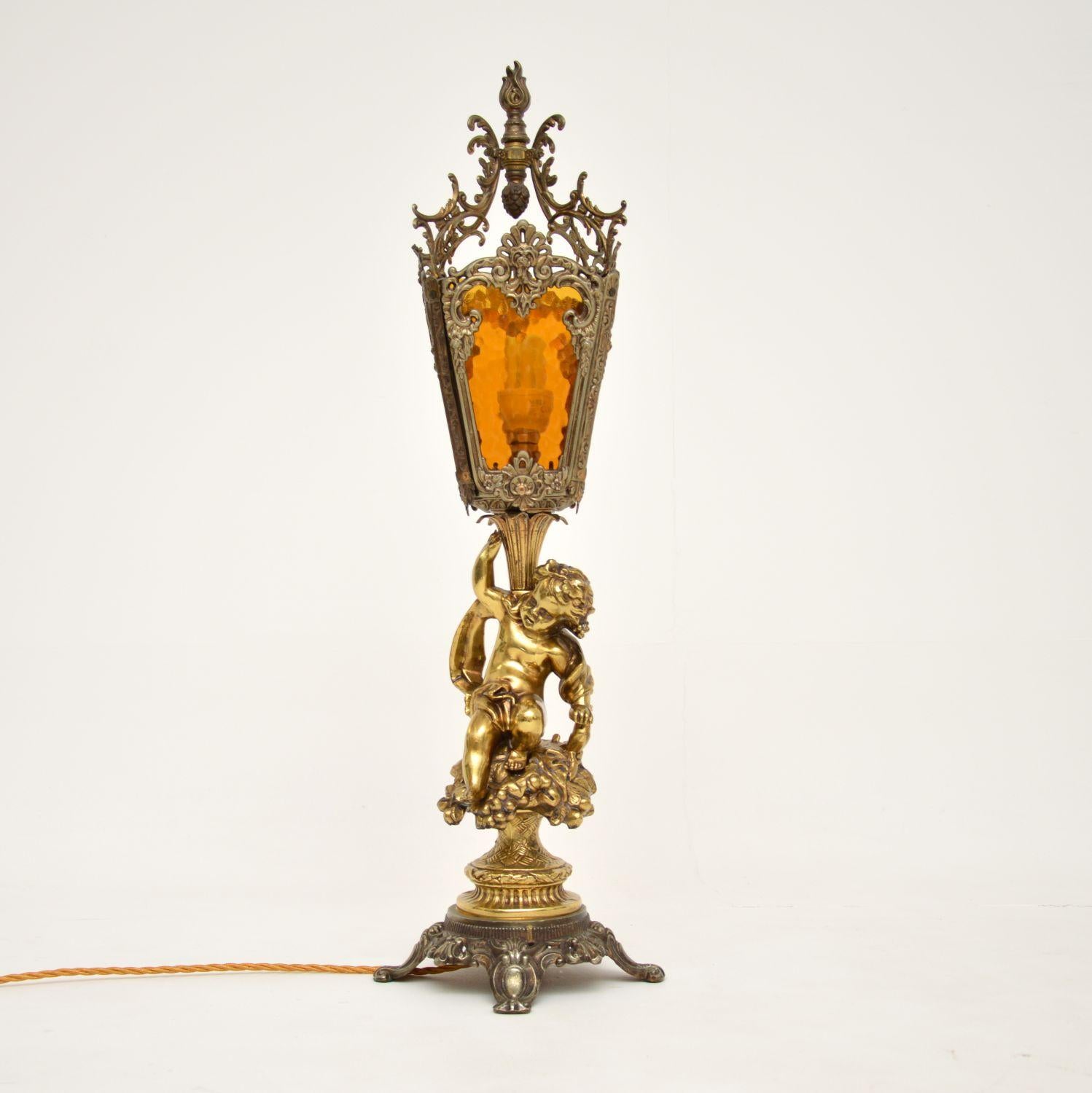 A large and stunning antique table lamp in gilt metal & brass, with original textured glass shade inserts. We believe it’s French & dates from around the 1930-50’s period.

It is of absolutely wonderful quality, with beautiful details all over. The