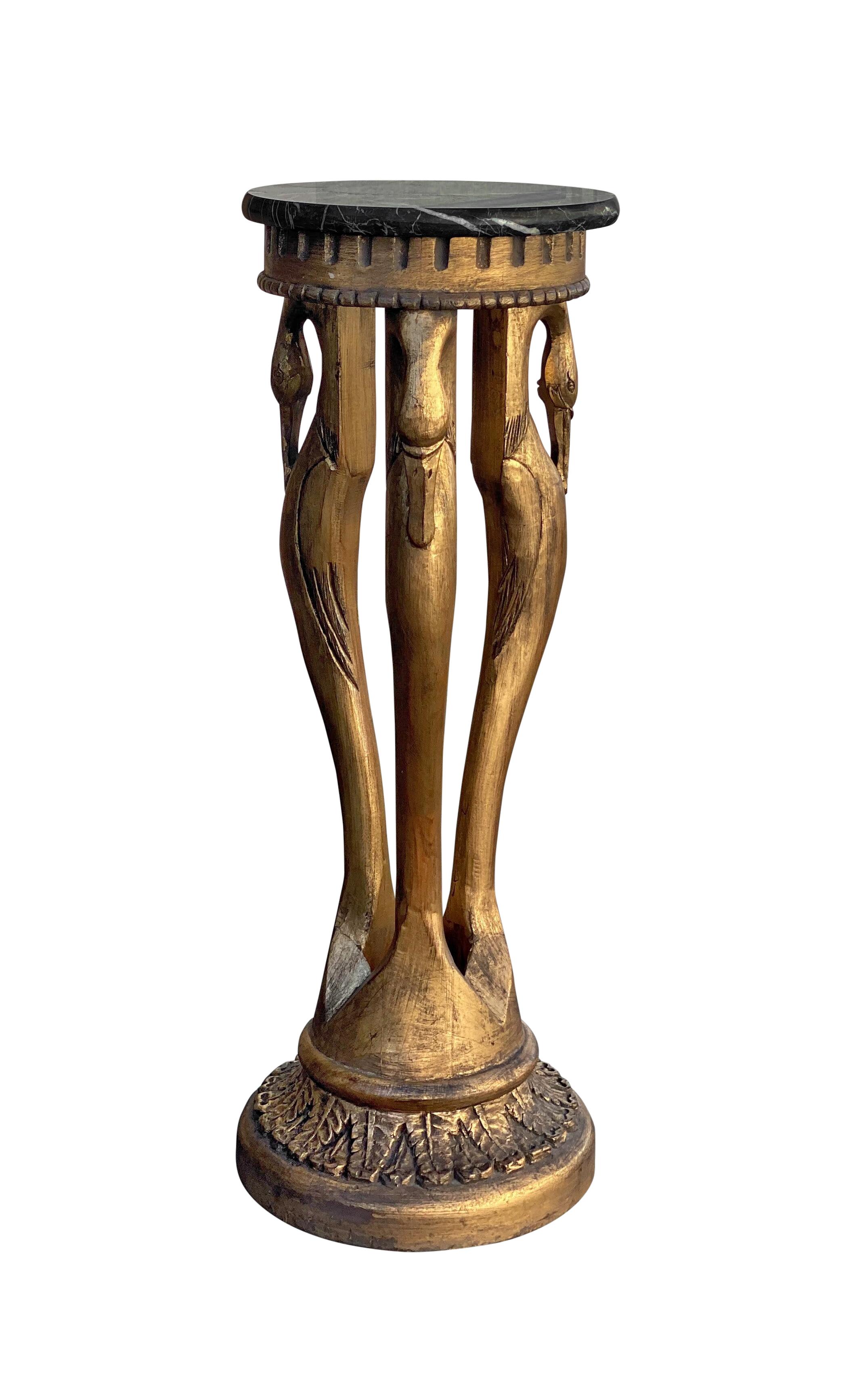 A beautiful French style swan pedestal table, featuring a polished black marble top with white veining, and a gilt finish on carved wood. Marble table top is not permanently fixed to base, but could be glued on if you so desire. Three swans adorn