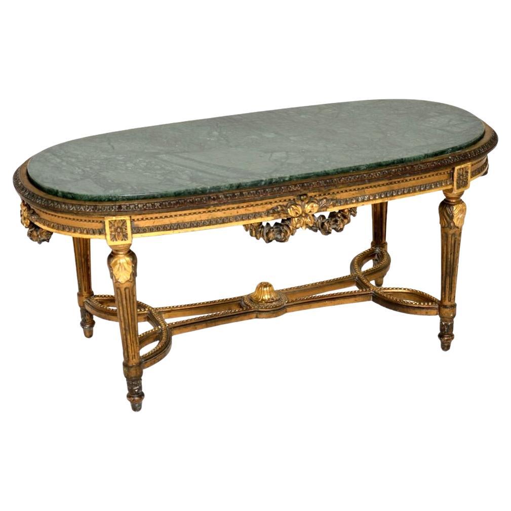 Table basse ancienne en bois doré avec plateau en marbre
