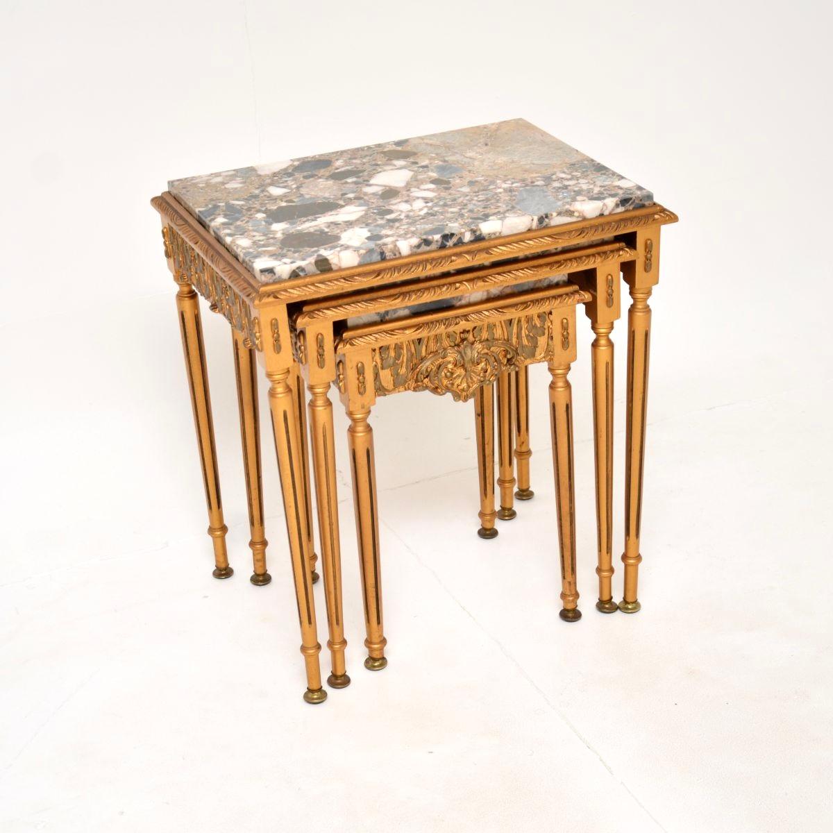 A beautiful antique French gilt wood marble top nest of tables, dating from around the 1930’s.

They have a stunning design, the gilt frames are made from solid wood with ornate gesso mouldings. The marble tops have gorgeous colour tones and