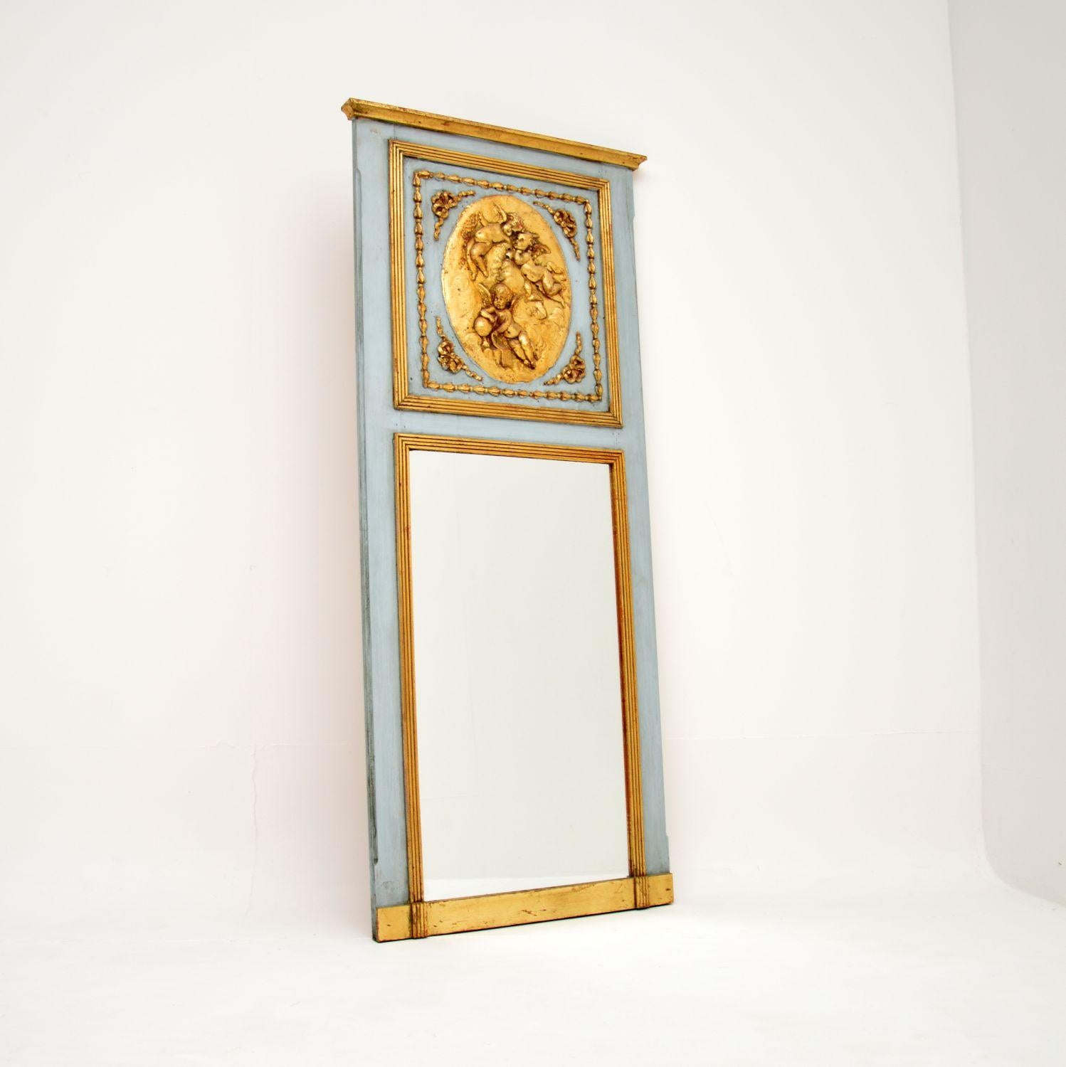 A stunning antique French slim over mantle mirror by renowned sculptor Leon Bertaux (b. 1827). This dates from around the 1860-1880 period.

It is of amazing quality, with a gorgeous central carved plaque depicting three cherubs, with the artists