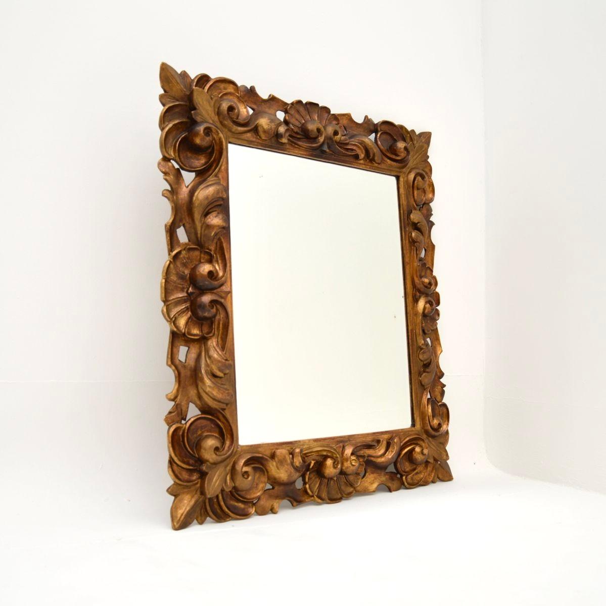 A stunning antique French gilt wood Rococo style mirror, dating from around the 1900-1920 period.

It is of extremely fine quality, it has beautiful and elaborately carved designs. This has a gorgeous patina and lustre, the glass has bevelled