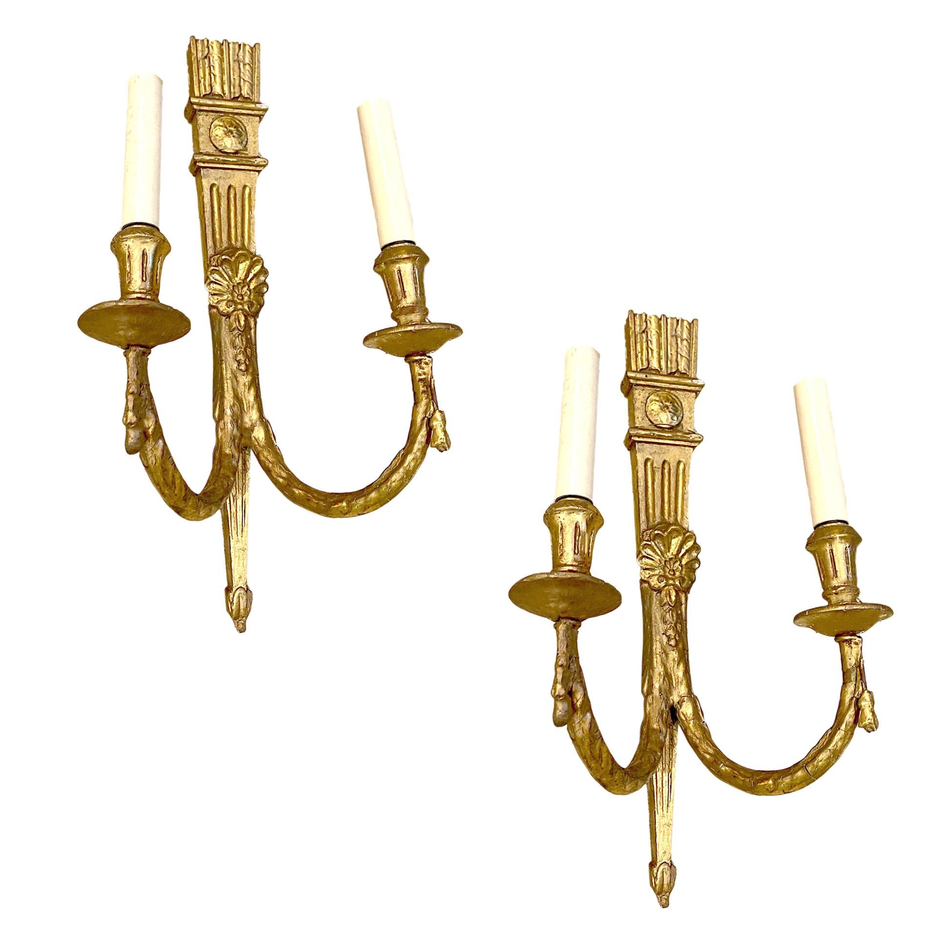 Pair of antique circa 1920s French carved and giltwood neoclassic style sconces.

Measurements:
Height 17