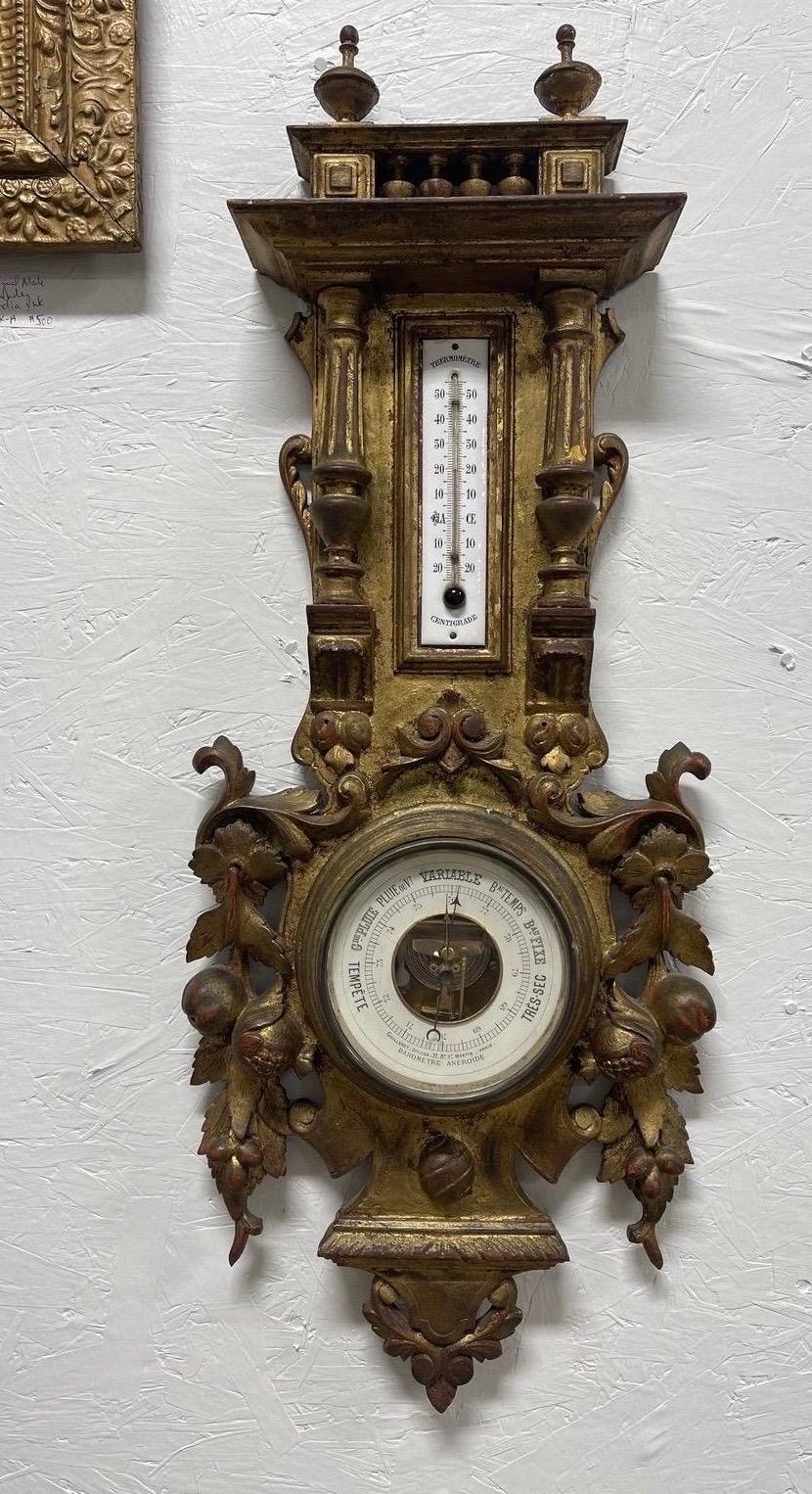 An early 20th century french gilt wood wall mounted barometer & thermometer combo. Fine detailing to the carving across the object - original enamel face to thermometer.