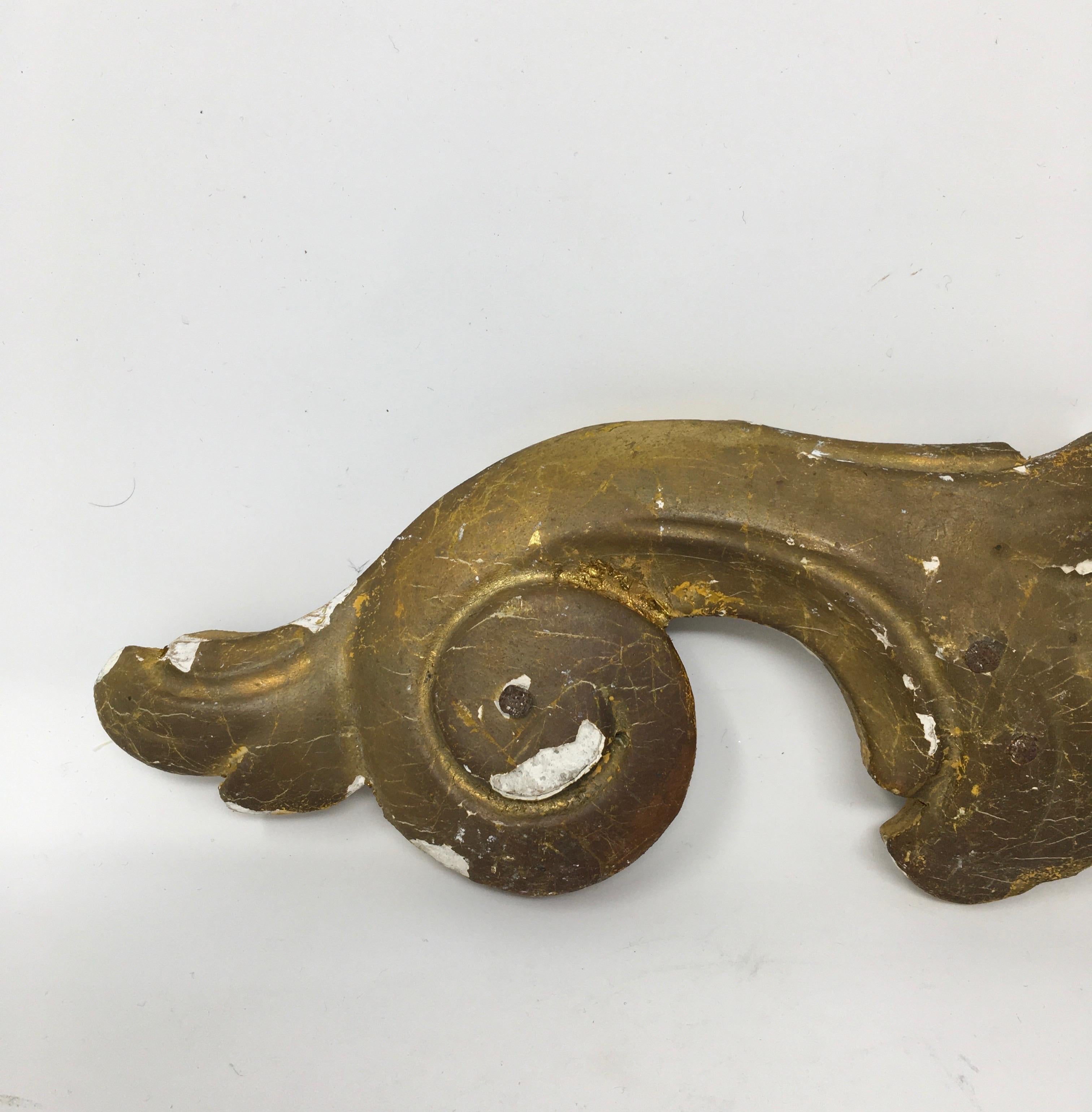 Found in the South of France, this hand carved gilt wood architectural fragment depicts a scroll design. The fragment is missing some of the gold patina that adds to the character. The piece would be great mounted as a sculptural piece on an iron or