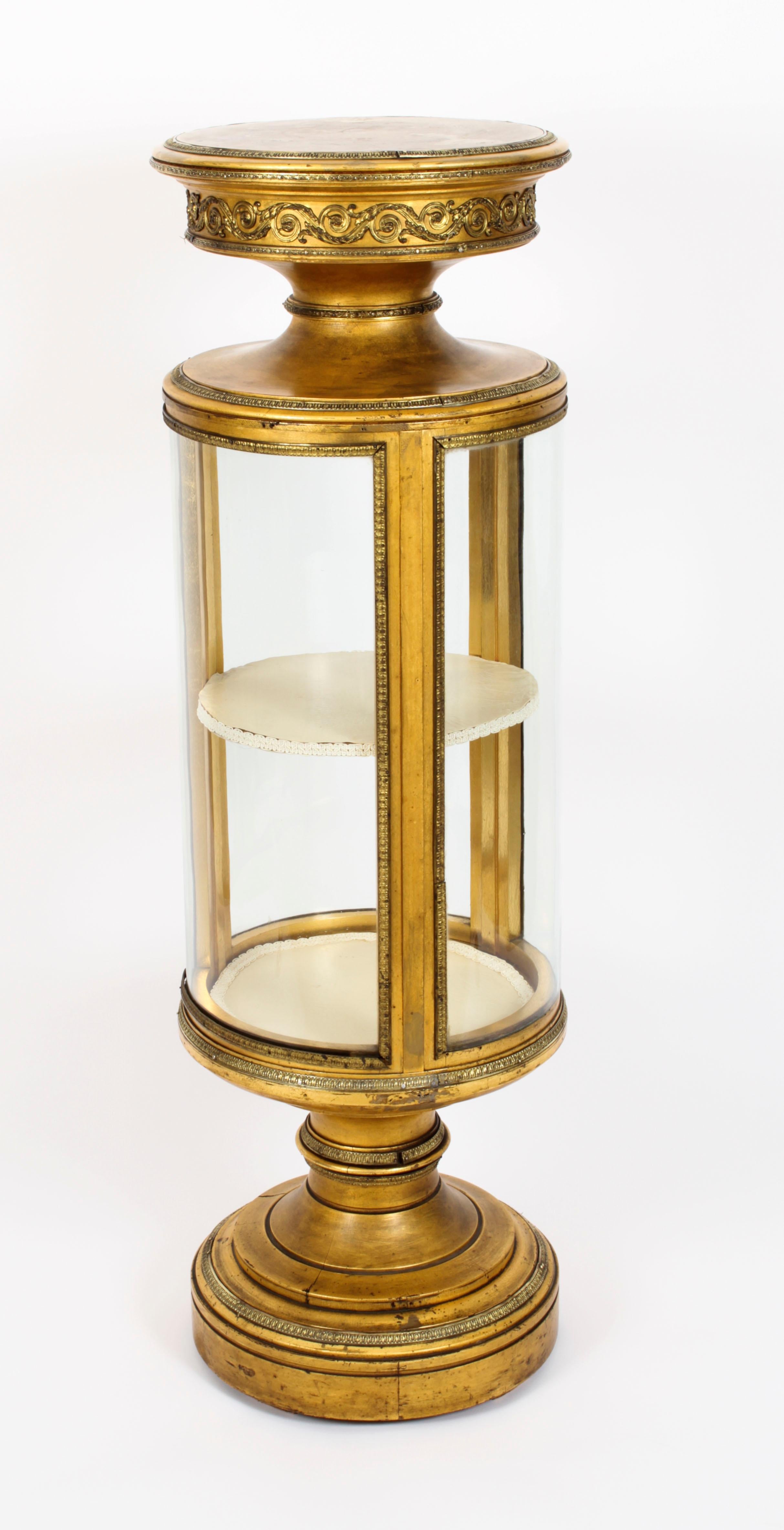 A superb, rare and unusual French giltwood and ormolu mounted cylindrical pedestal and combined glazed display cabinet, Circa 1860 in date.
 
The cabinet with wonderful ormolu mounts and raised on a circular pedetal base.
 
Add a touch of French