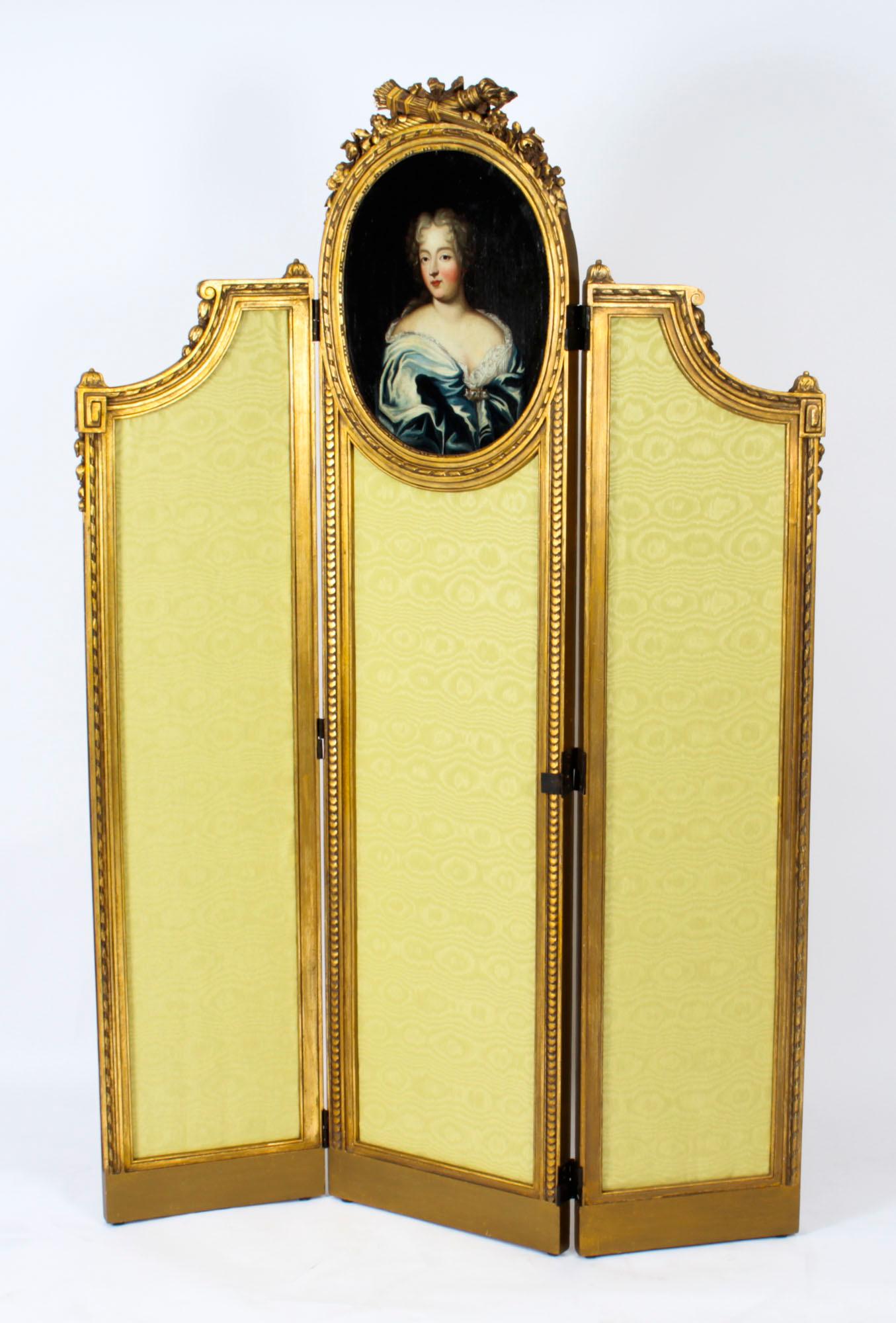 A fine beautiful antique French Louis Revival giltwood three panel dressing screen with portrait, circa 1850 in date.

The screen features three beautifully carved beaded egg and dart rectangular frames each with gold silk upholstered panels. The