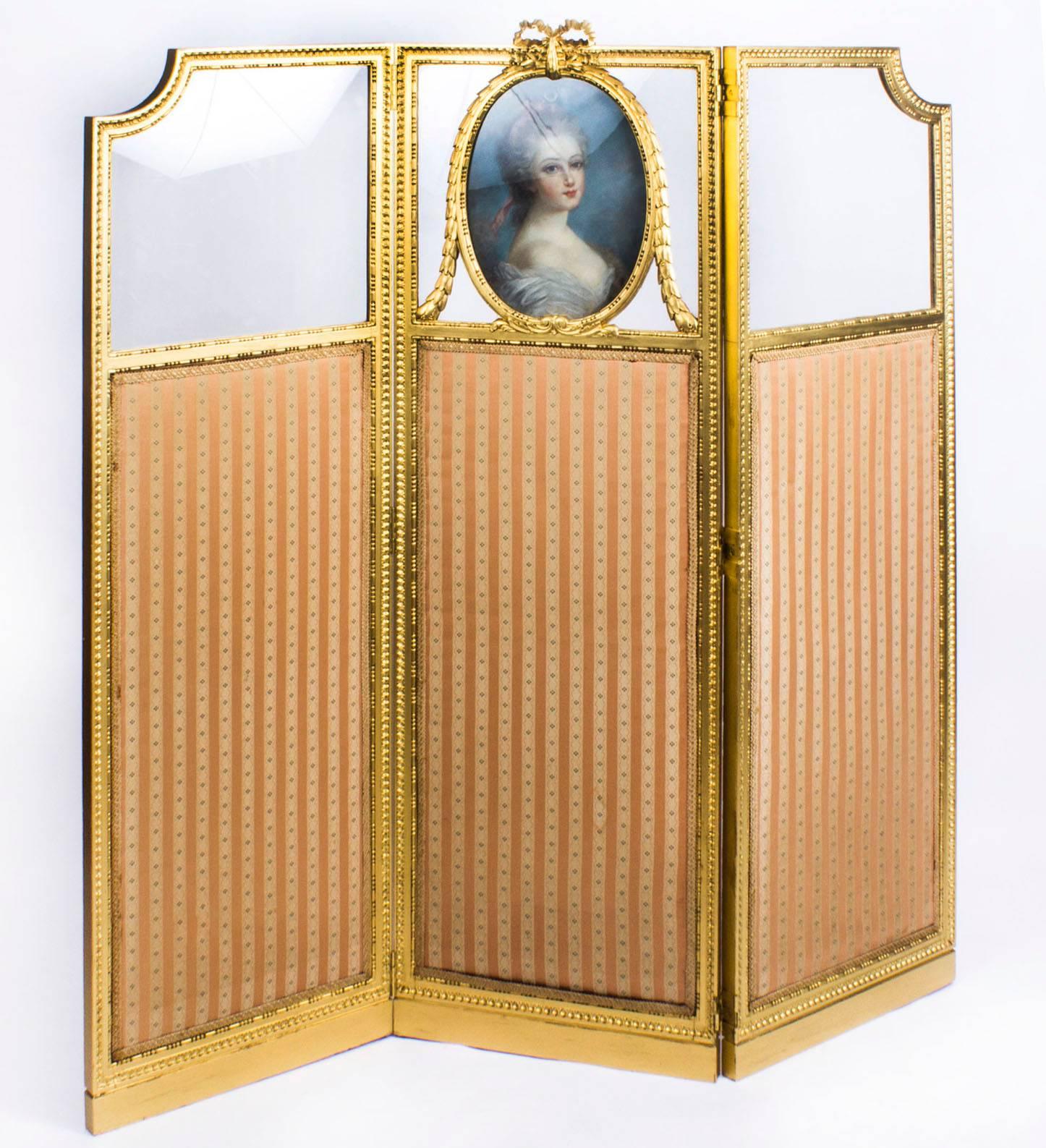 A fine beautiful antique French Louis Revival giltwood dressing screen, circa 1870 in date.

The screen features three beautifully carved beaded egg and dart rectangular frames each with gold and floral striped upholstered panels. The shaped tops
