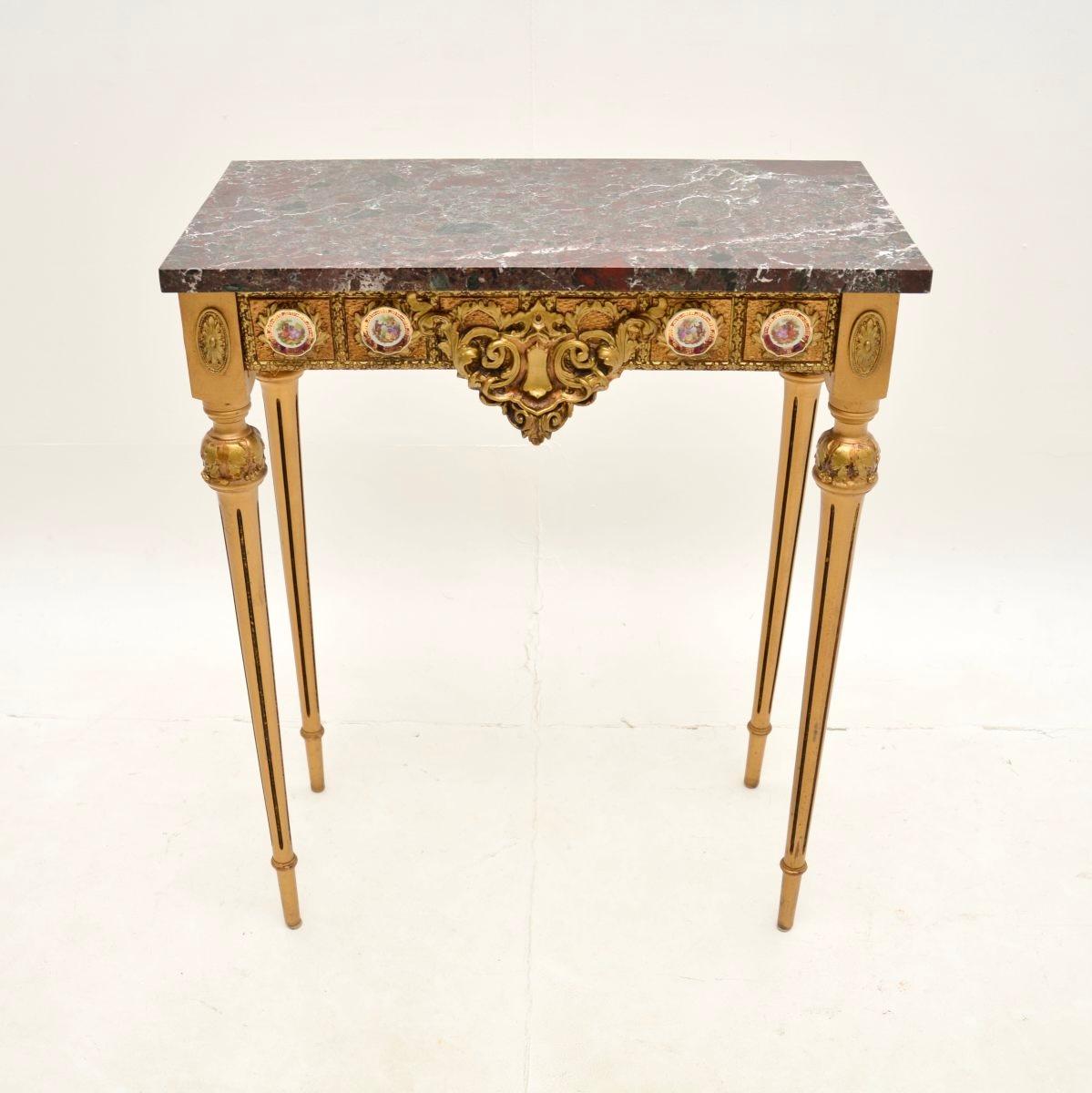 A beautiful antique French giltwood marble top console / side table. This was made in France, it dates from around the 1950’s.

The quality is superb, the wood is beautifully carved with intricate details. This has amazing porcelain Limoge hand