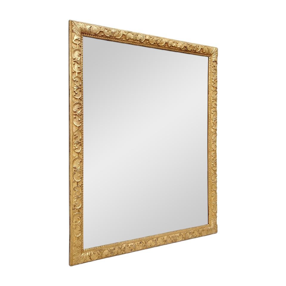 Antique French mirror, circa 1930. Giltwood frame with ornaments in the 
