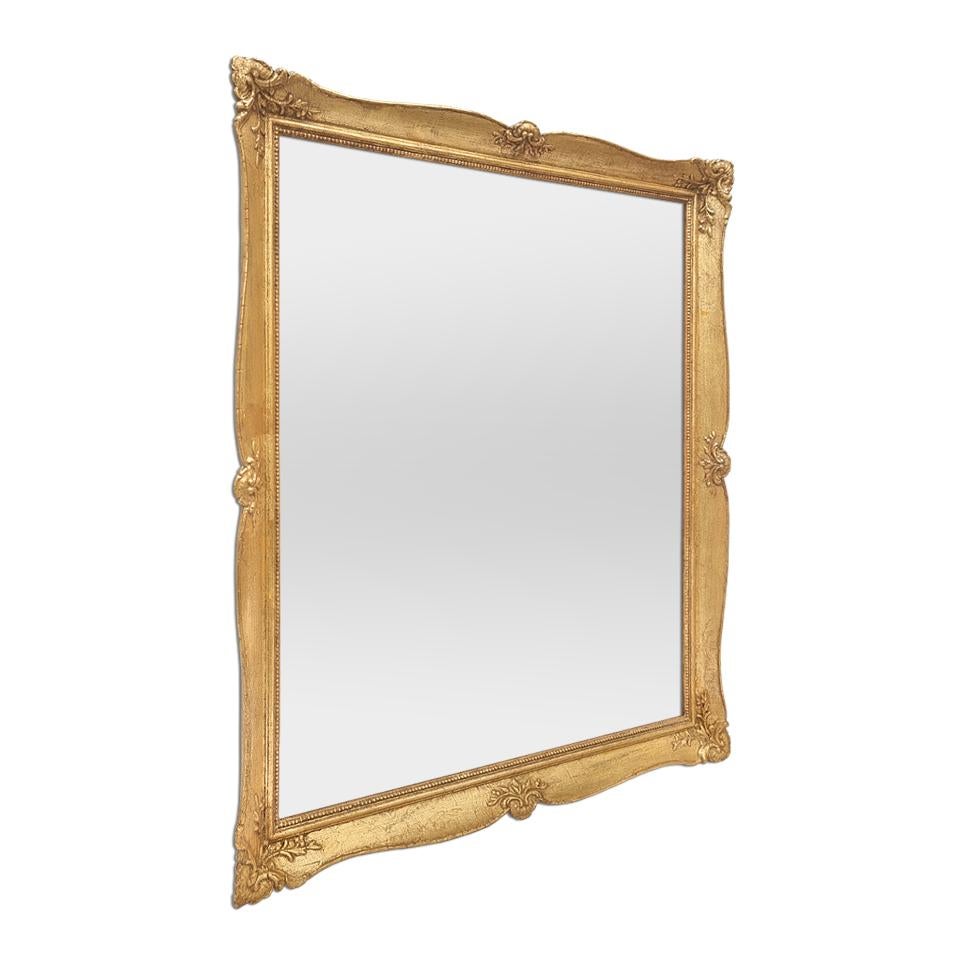 Antique French giltwood mirror, Louis XV style inspiration, circa 1940. Re-gilding to the leaf patinated adorned with shells decoration and pearls around the edge glass mirror. (Antique frame width measures: 4 cm / 1.57 in.). Modern glass mirror.