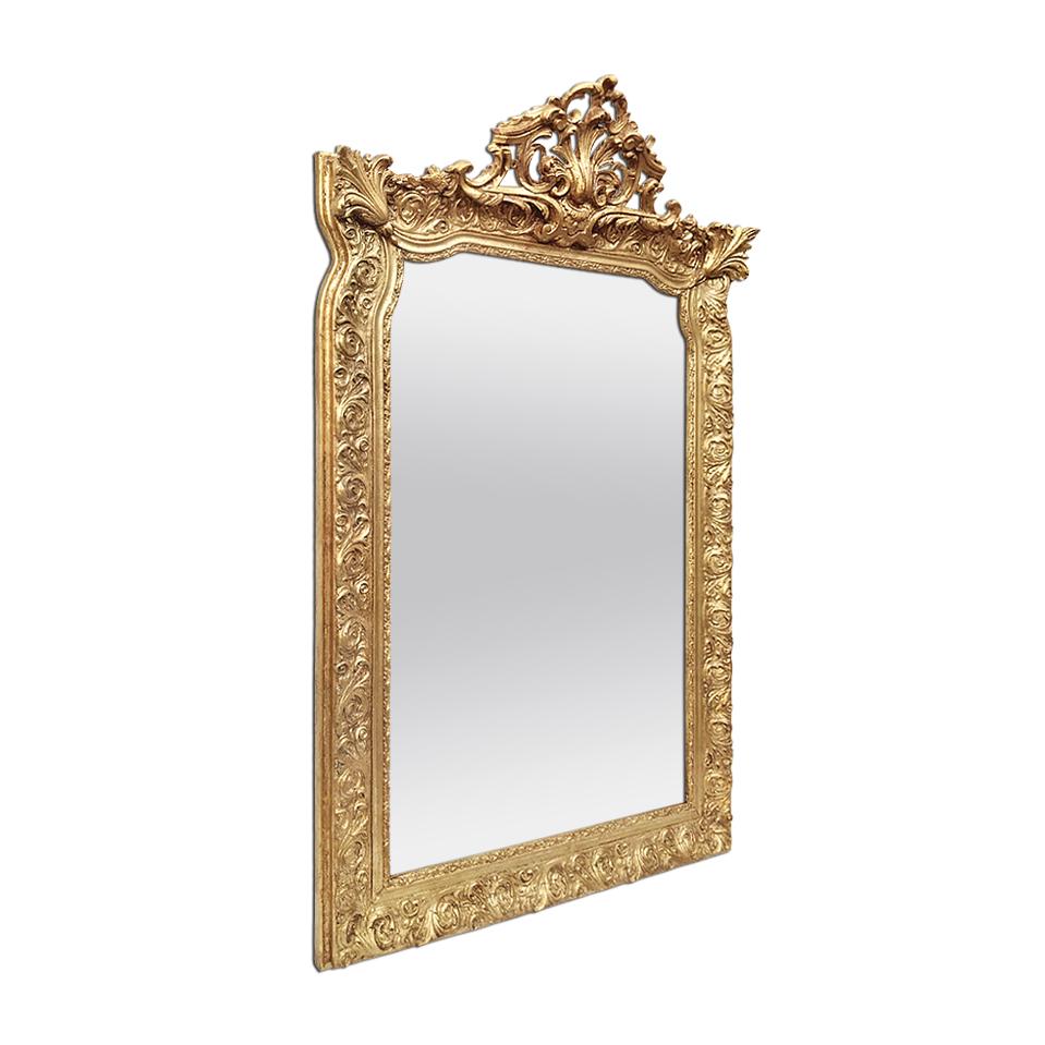 Large antique giltwood french mirror Napoleon III style, circa 1880. Decorations inspired by Louis XV and Louis XIV styles, a pediment and frame decorated with stylized scrolls and foliage and two shells with carved foliages in the corners.