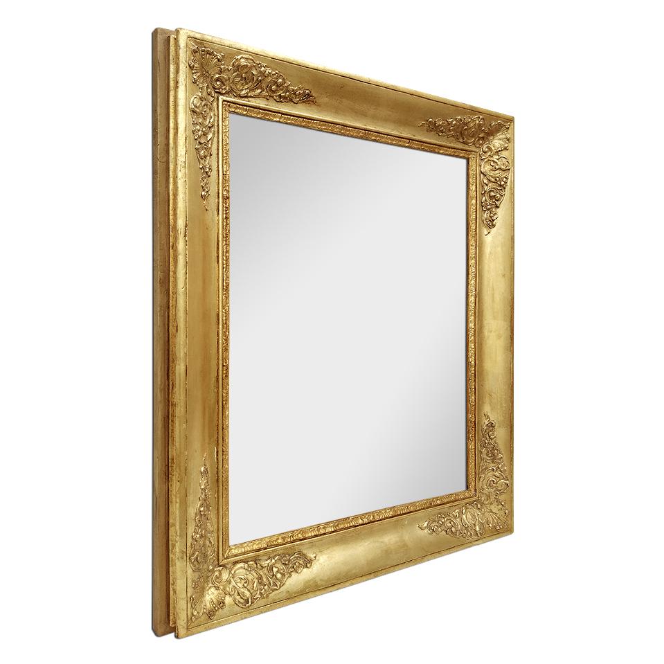 Antique giltwood mirror, French Restoration period, circa 1820. Antique frame with plant ornaments in the corners and rais-de-cœur around the glass mirror (frame width: 9.5 cm / 3.74 in.). Re-gilding to the leaf patinated. Modern glass mirror.