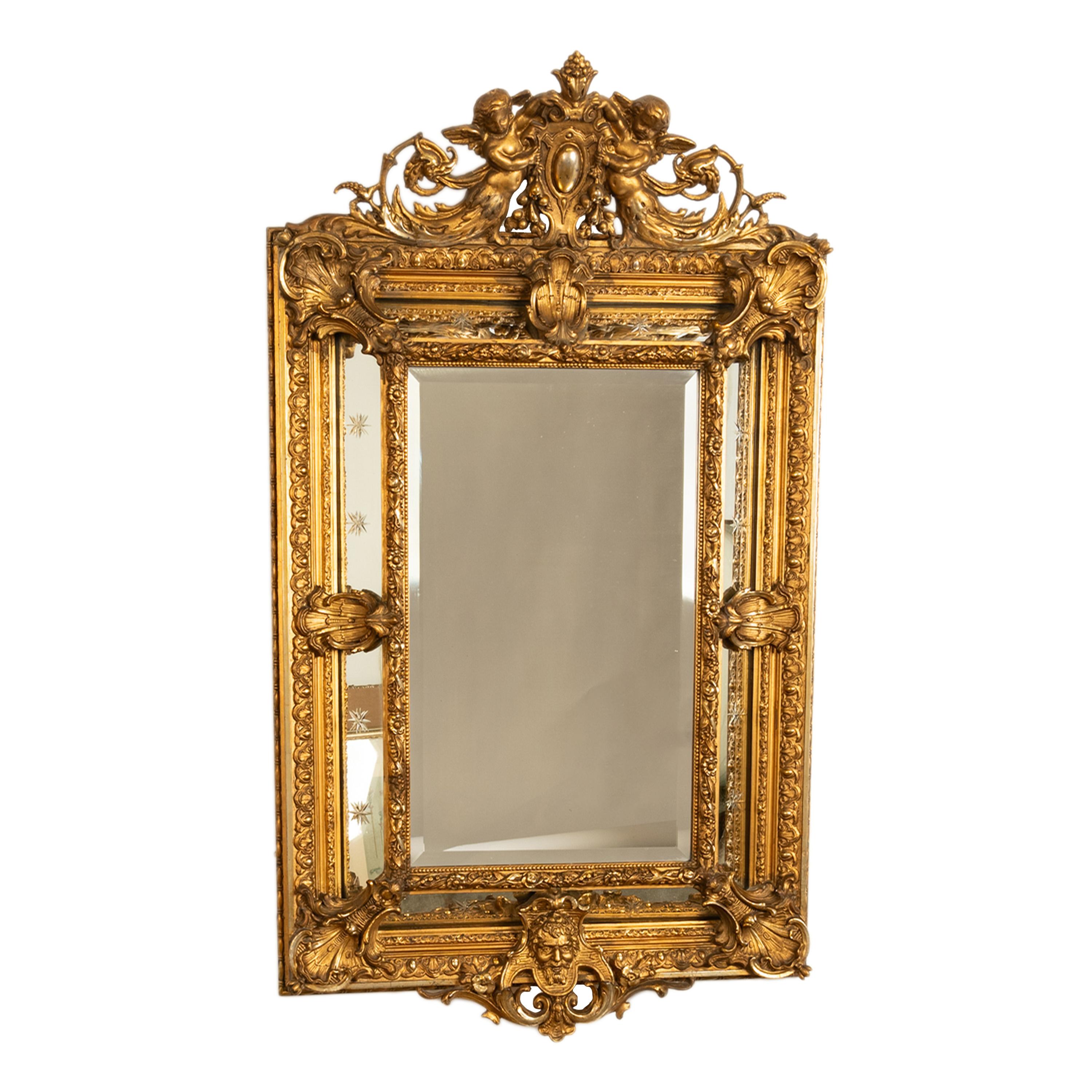A large & fine antique 19th century French giltwood Louis XV Rococo mirror, of superior quality, circa 1870.
The mirror having an shield shaped cartouche to the top, held by a pair of winged cherubs. The mirror being of cushion shape and to the
